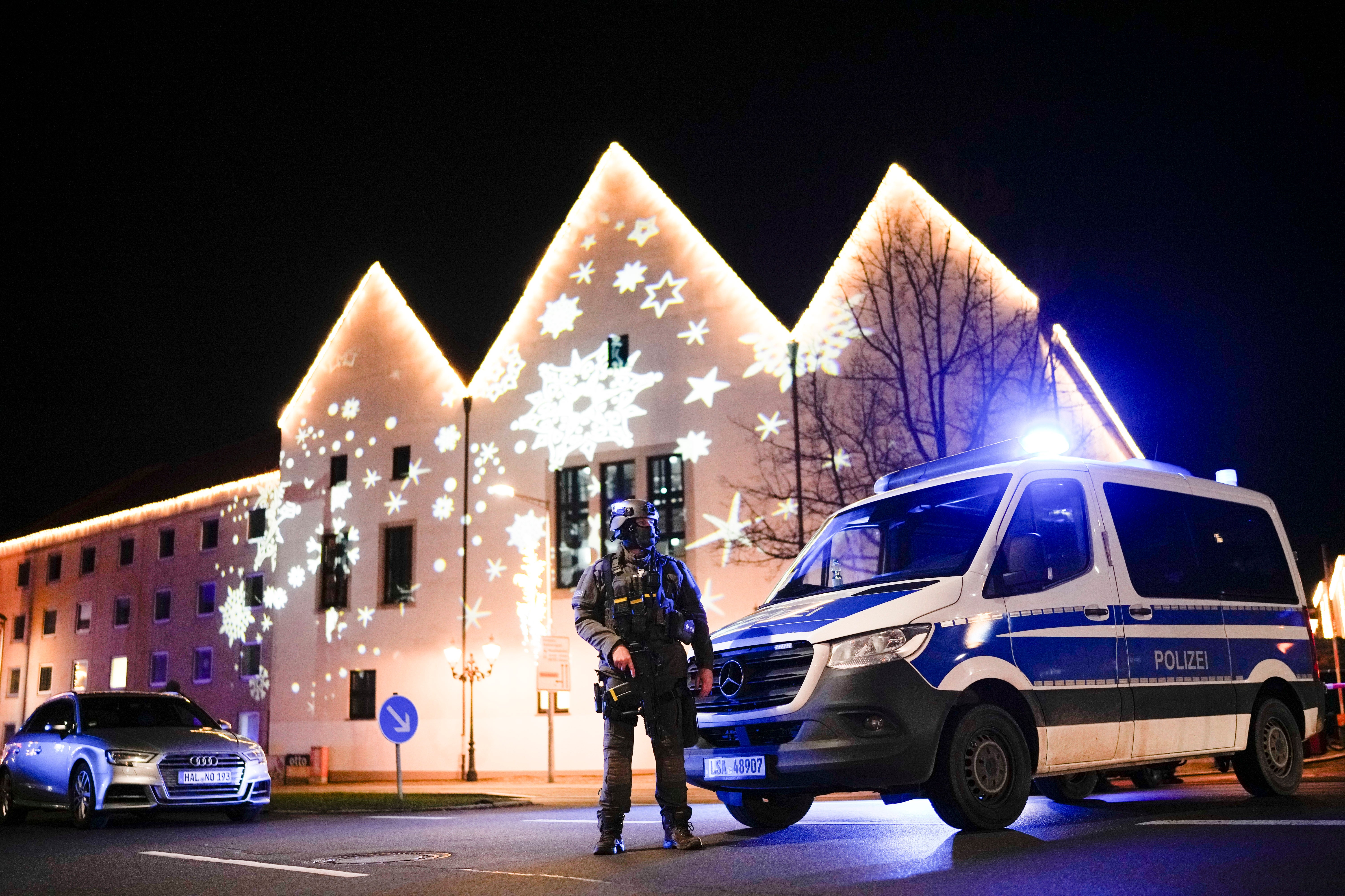 A police officer stands guard near the market on Friday night