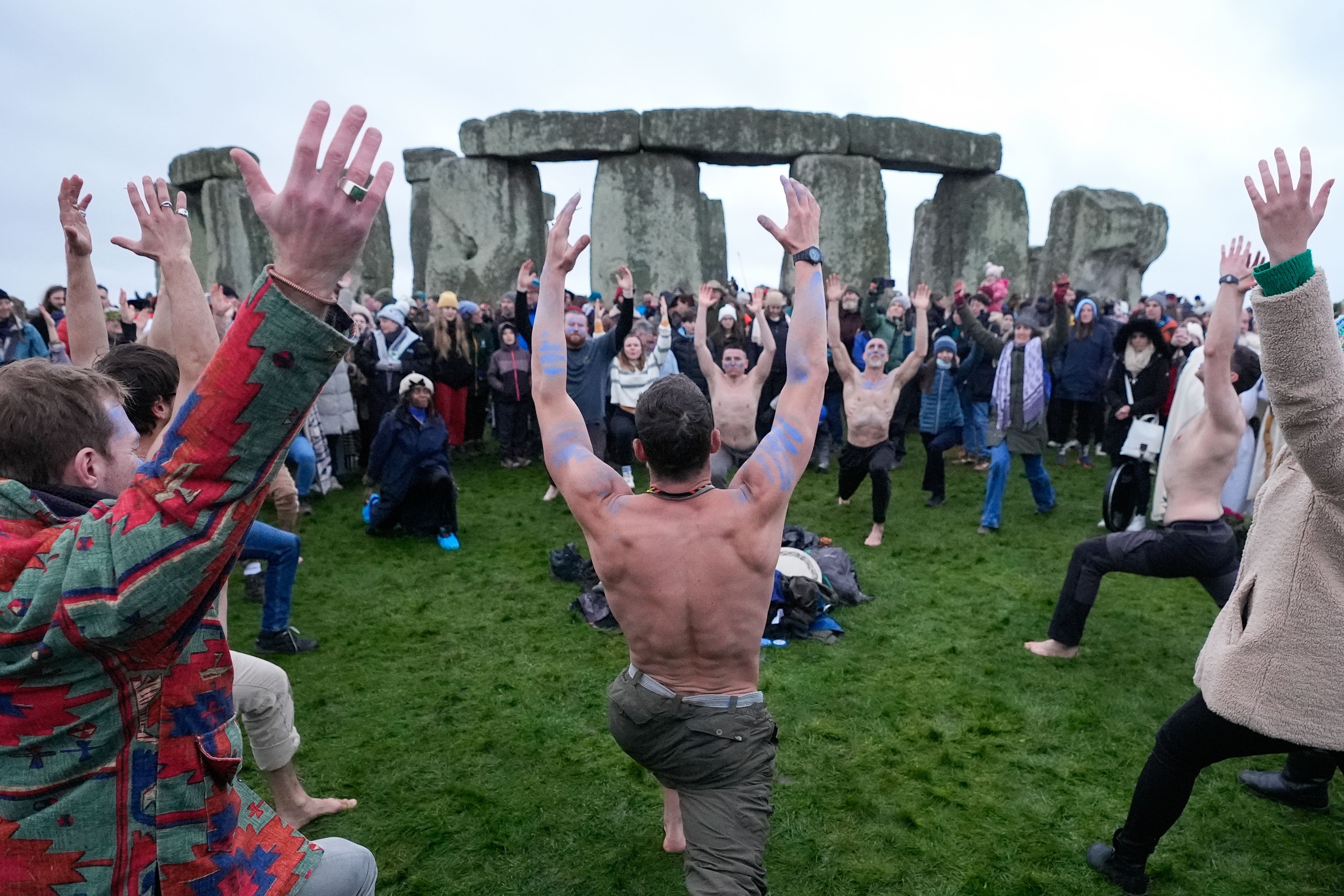 People take part in the winter solstice celebrations during sunrise at Stonehenge in Wiltshire (Andrew Matthews/PA)