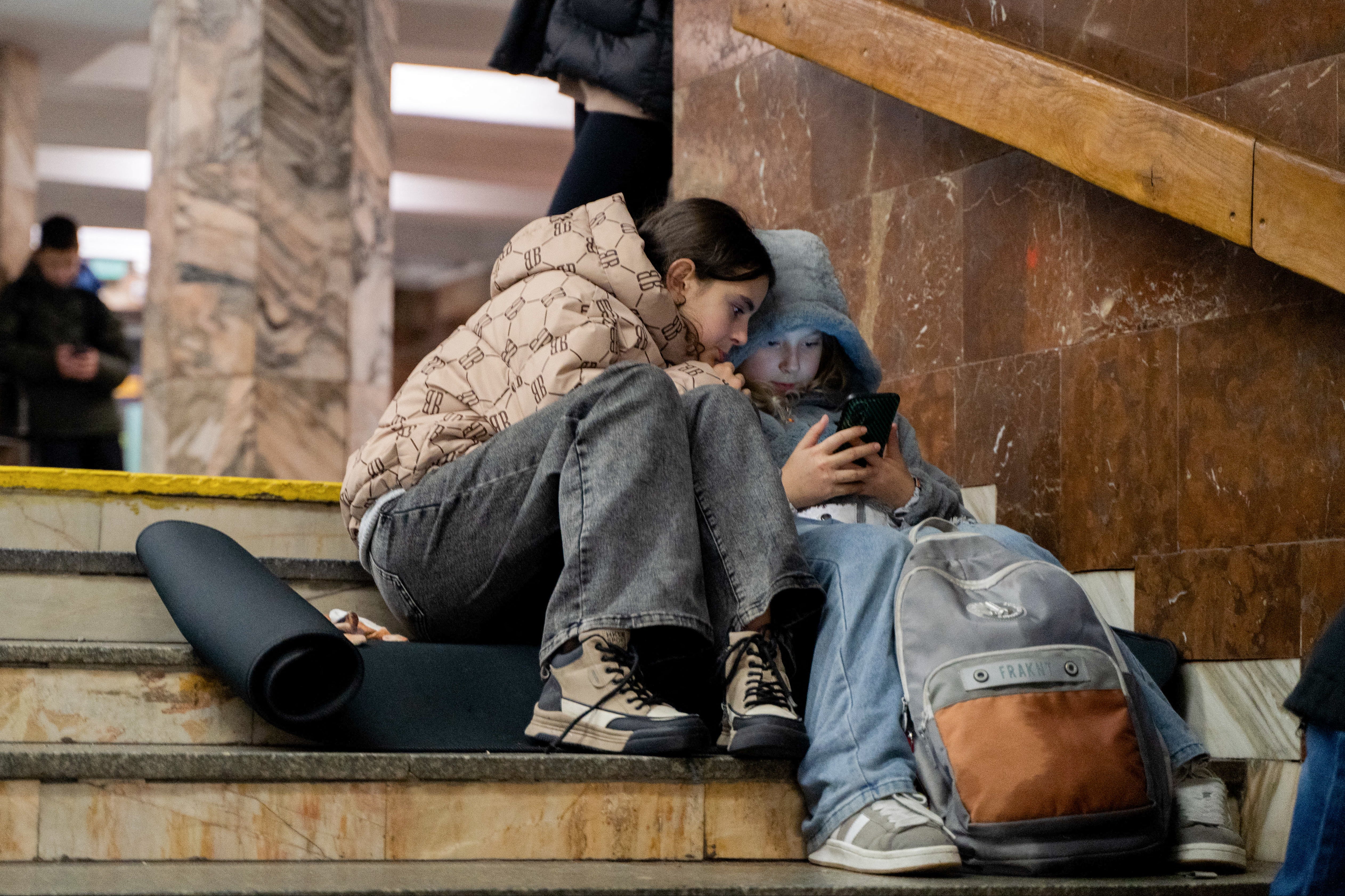 Children take shelter in a metro station during an airstrike alert in Kyiv