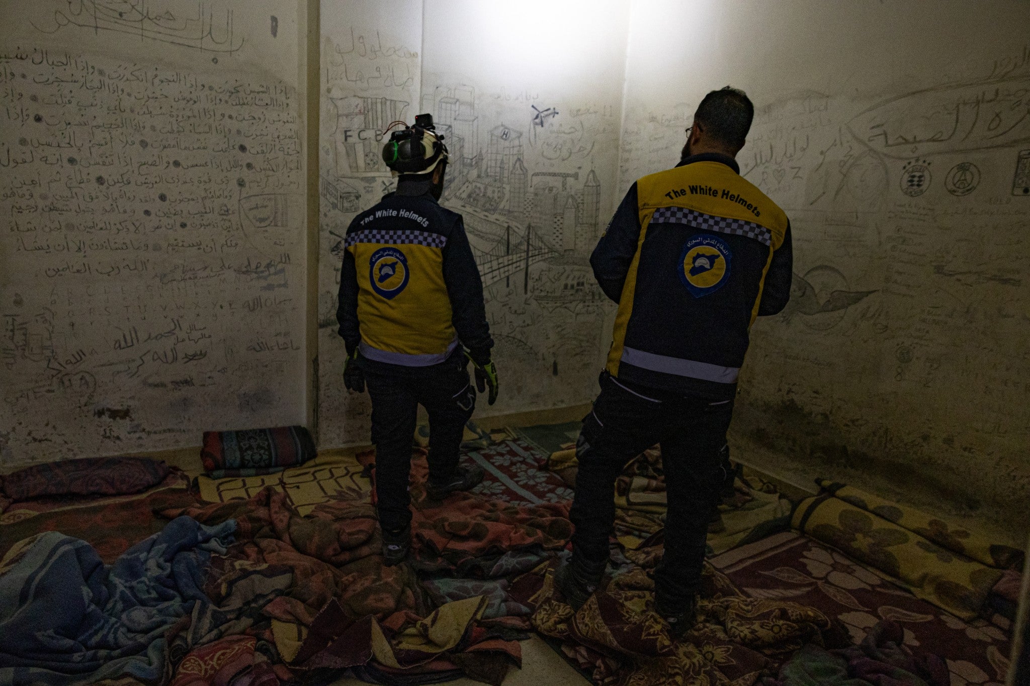 The White Helmets group look for secret underground cells at a prison in Damascus and fine English writing on a cell wall