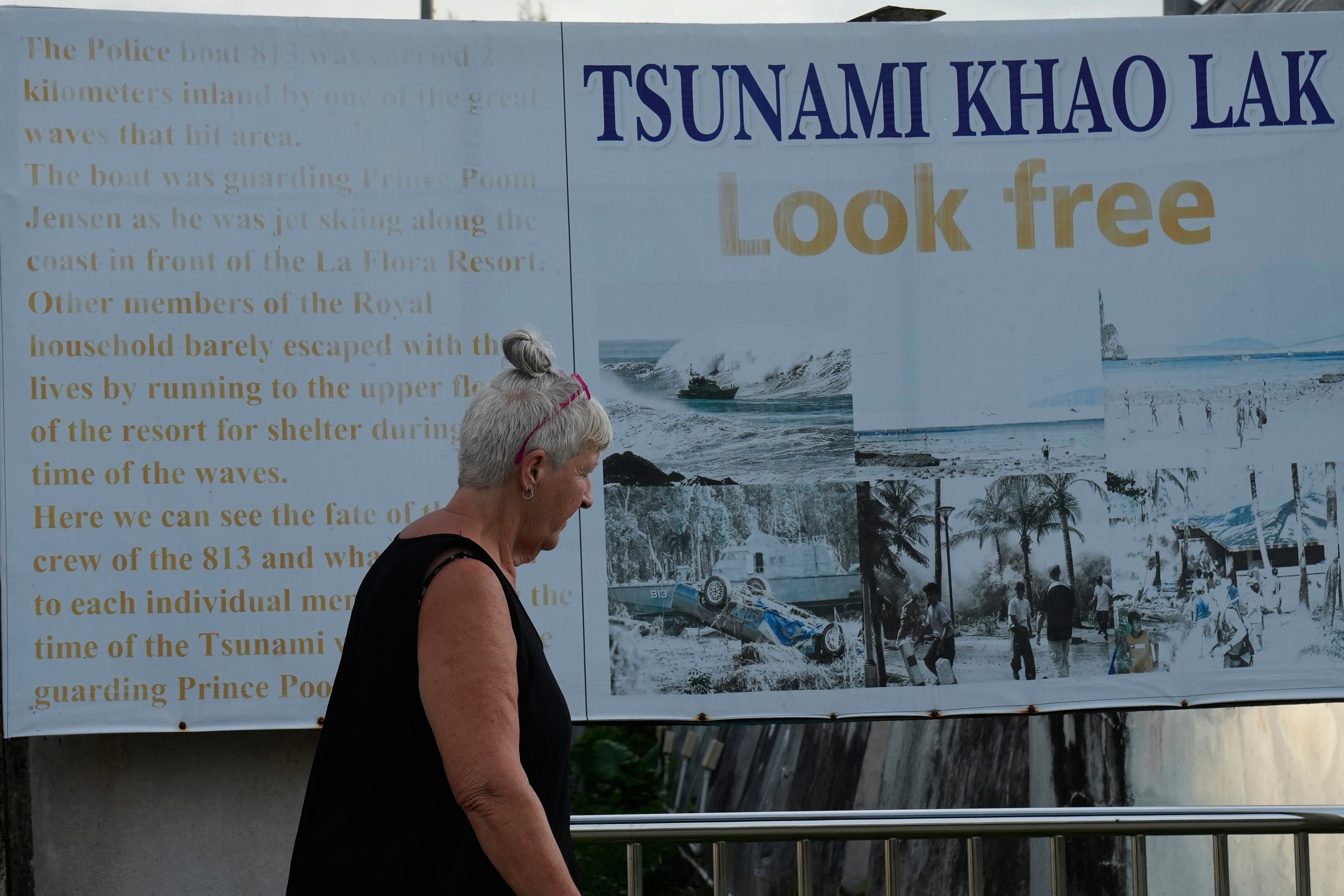 Tourist walk in from Tsunami Memorial poster at Khao Lak