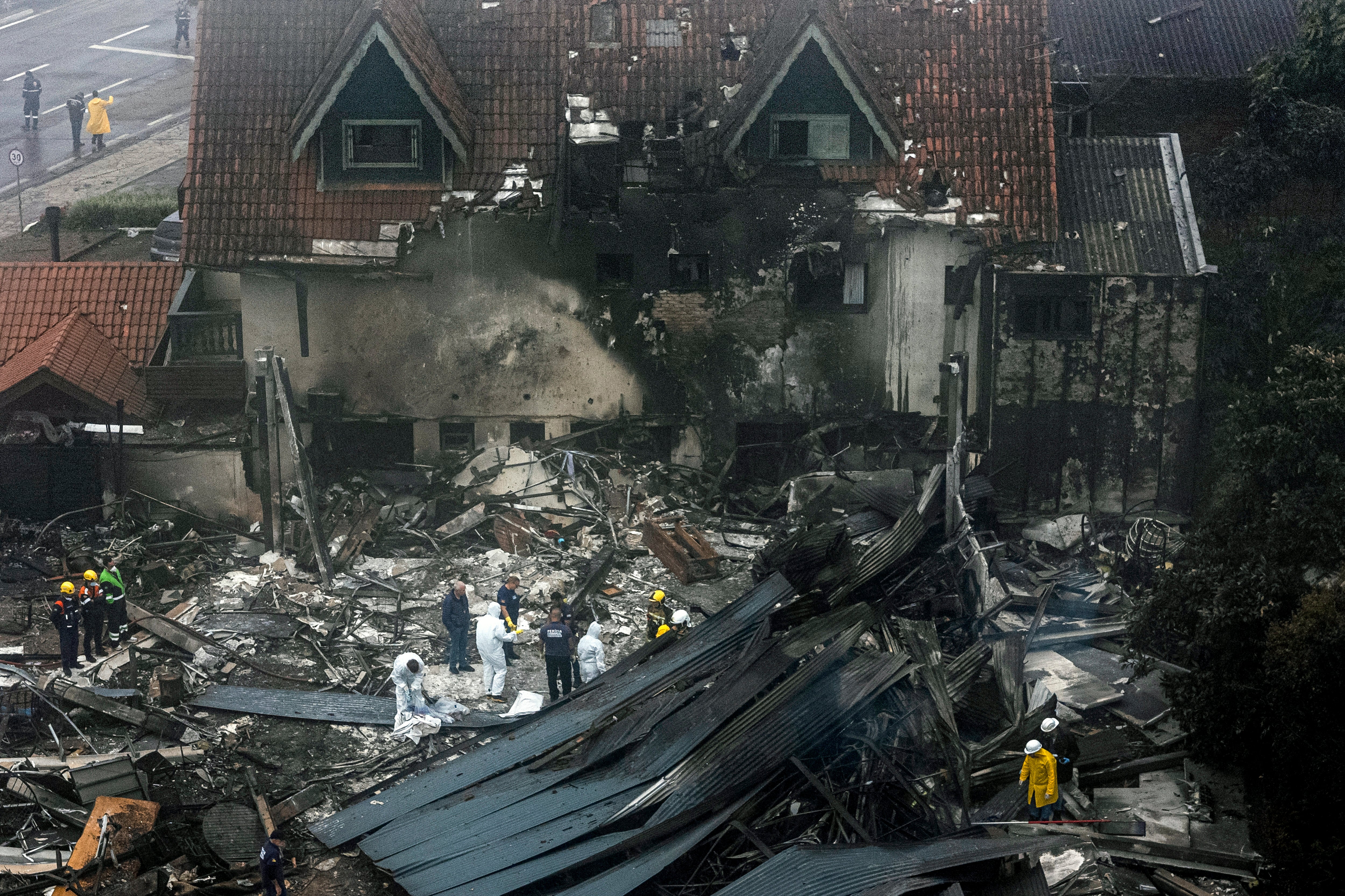 Firefighters and other rescue teams work in the site of a plane crash at the city of Gramado, Rio Grande do Sul state, Brazil, on 22 December 2024