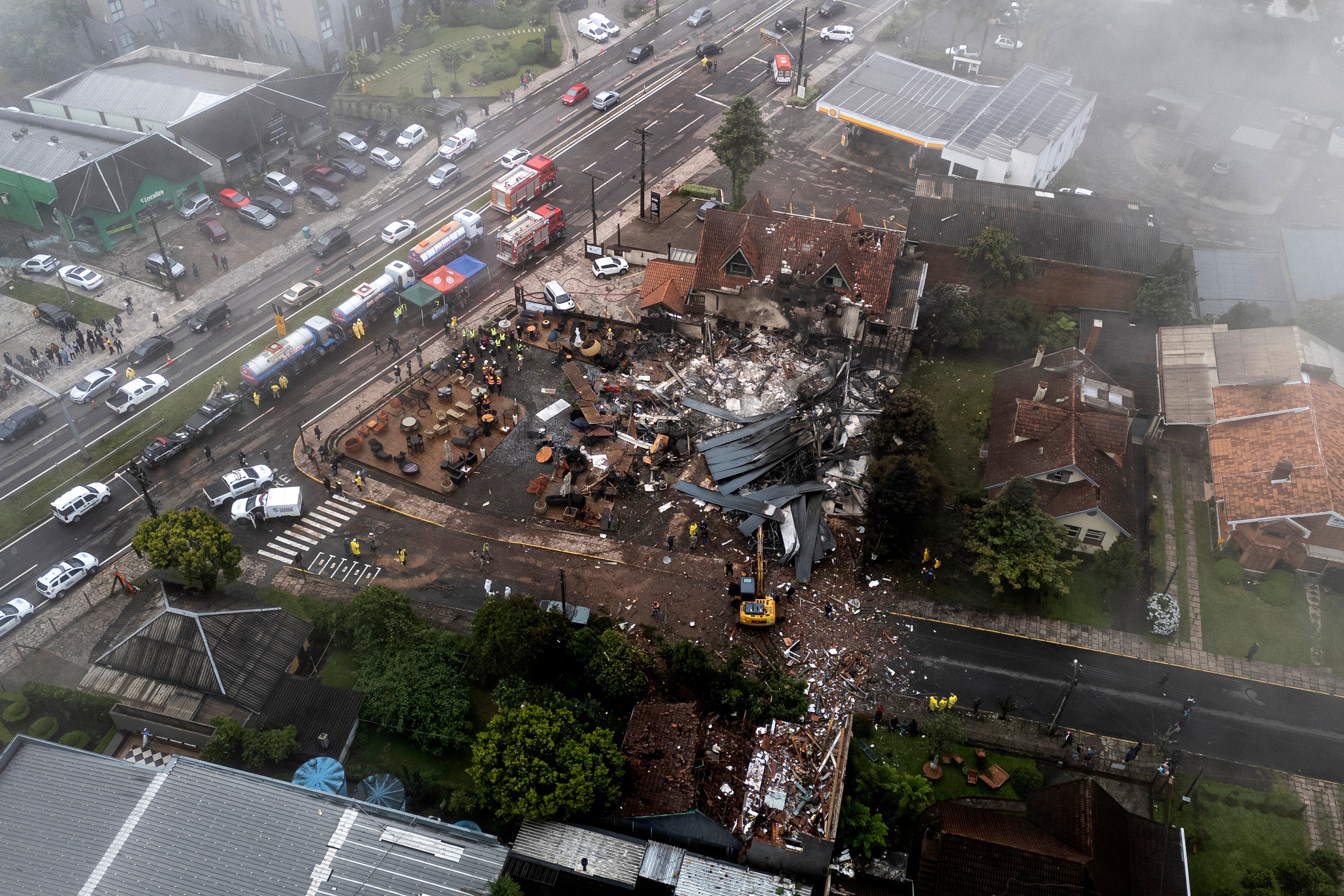 Police carry out an investigation by houses that were hit by a plane in Gramado, Rio Grande do Sul state