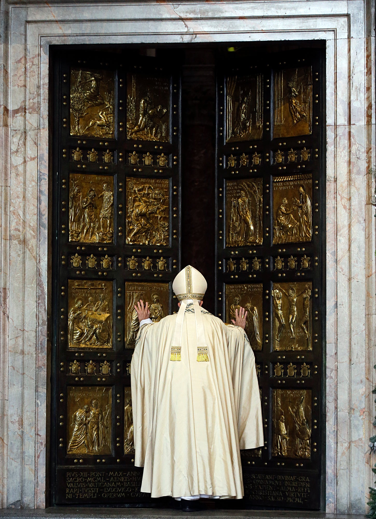 Pope Francis pushes open the Holy Door of St. Peter’s Basilica