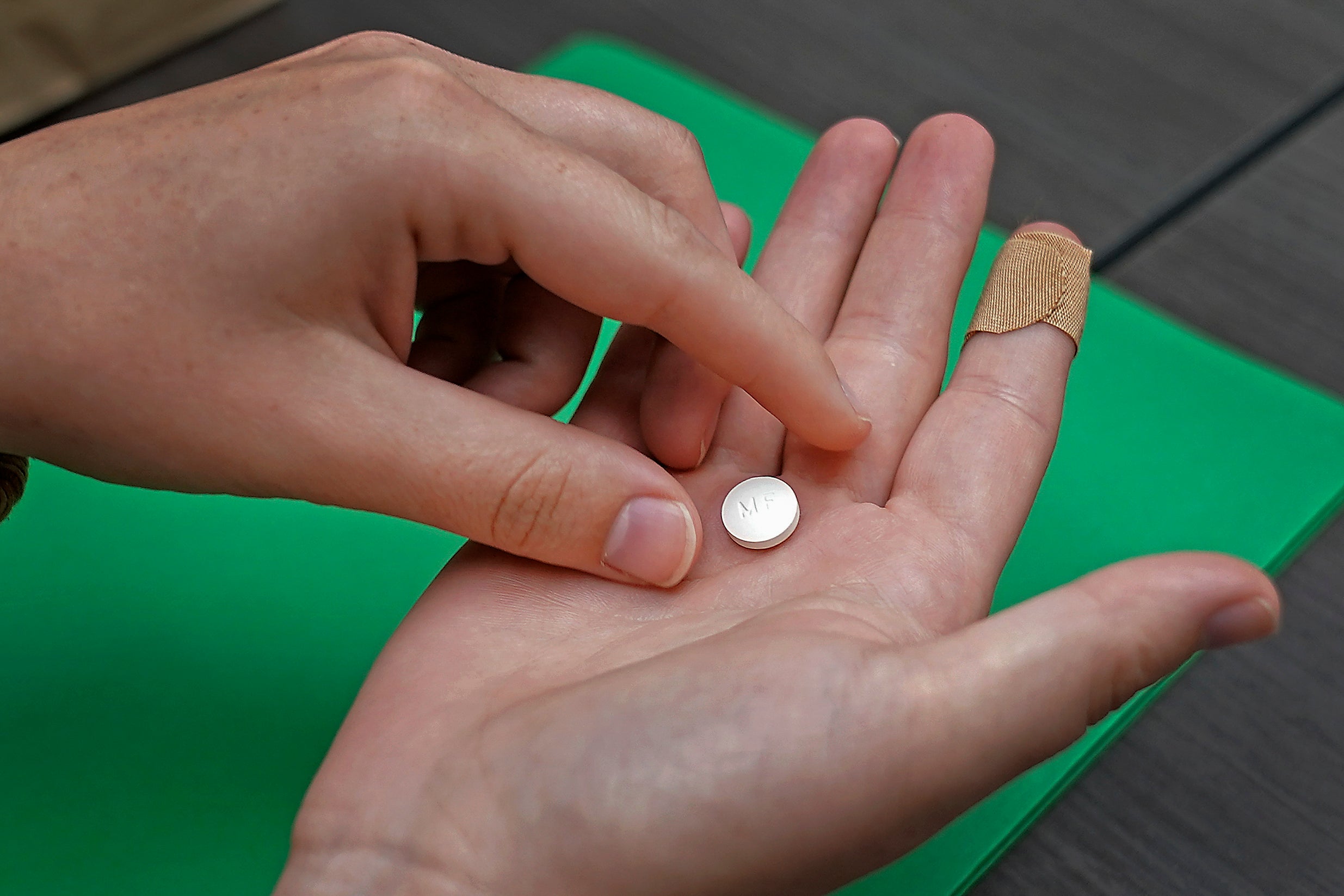A patient prepares to take the first of two pills for a medical abortion