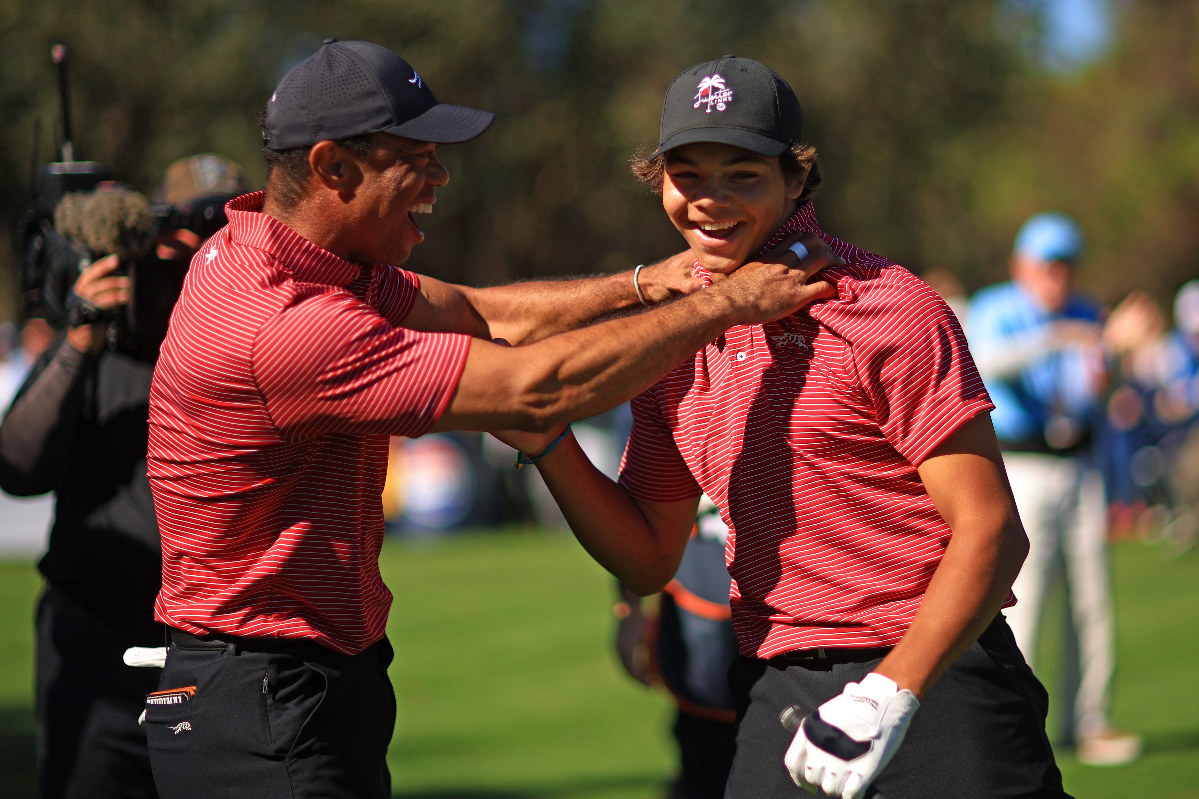 Tiger Woods and Charlie, 15, celebrate the hole in one