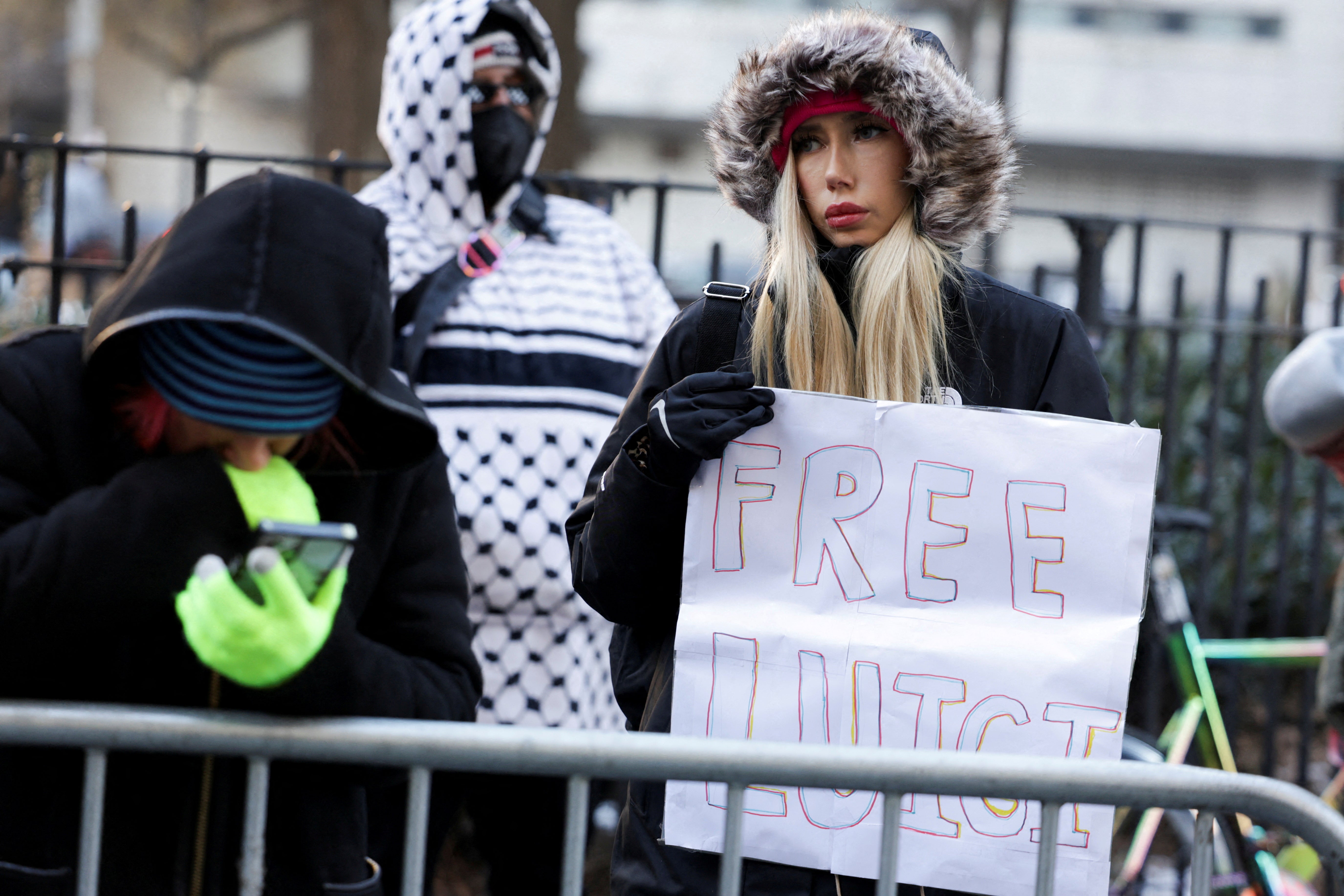 A demonstrator holds a sign that reads, ‘Free Luigi” outside of Mangione’s arraignment hearing