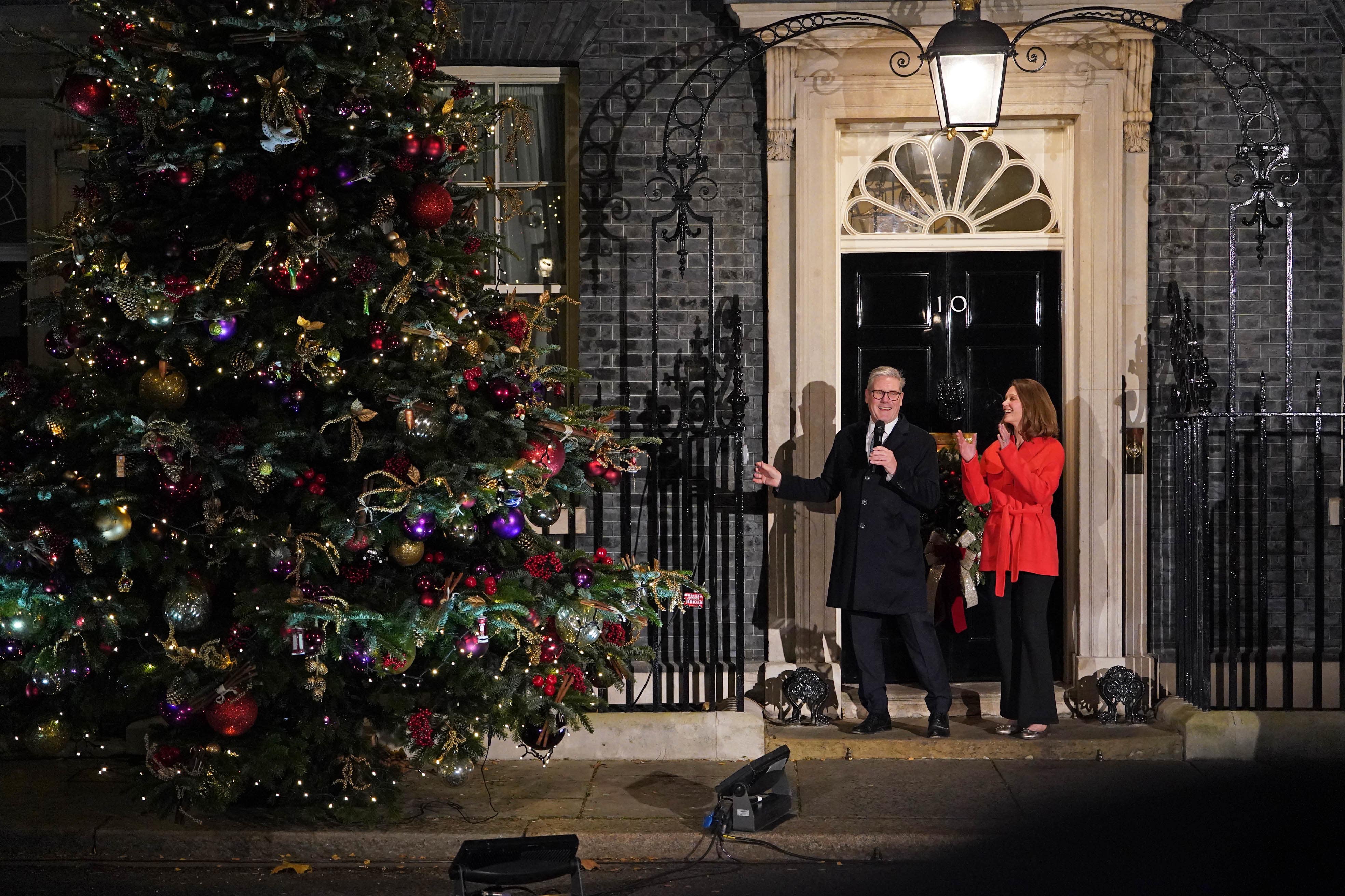 Prime Minister Sir Keir Starmer and his wife Lady Victoria Starmer switch on the Downing Street Christmas lights in London (PA)