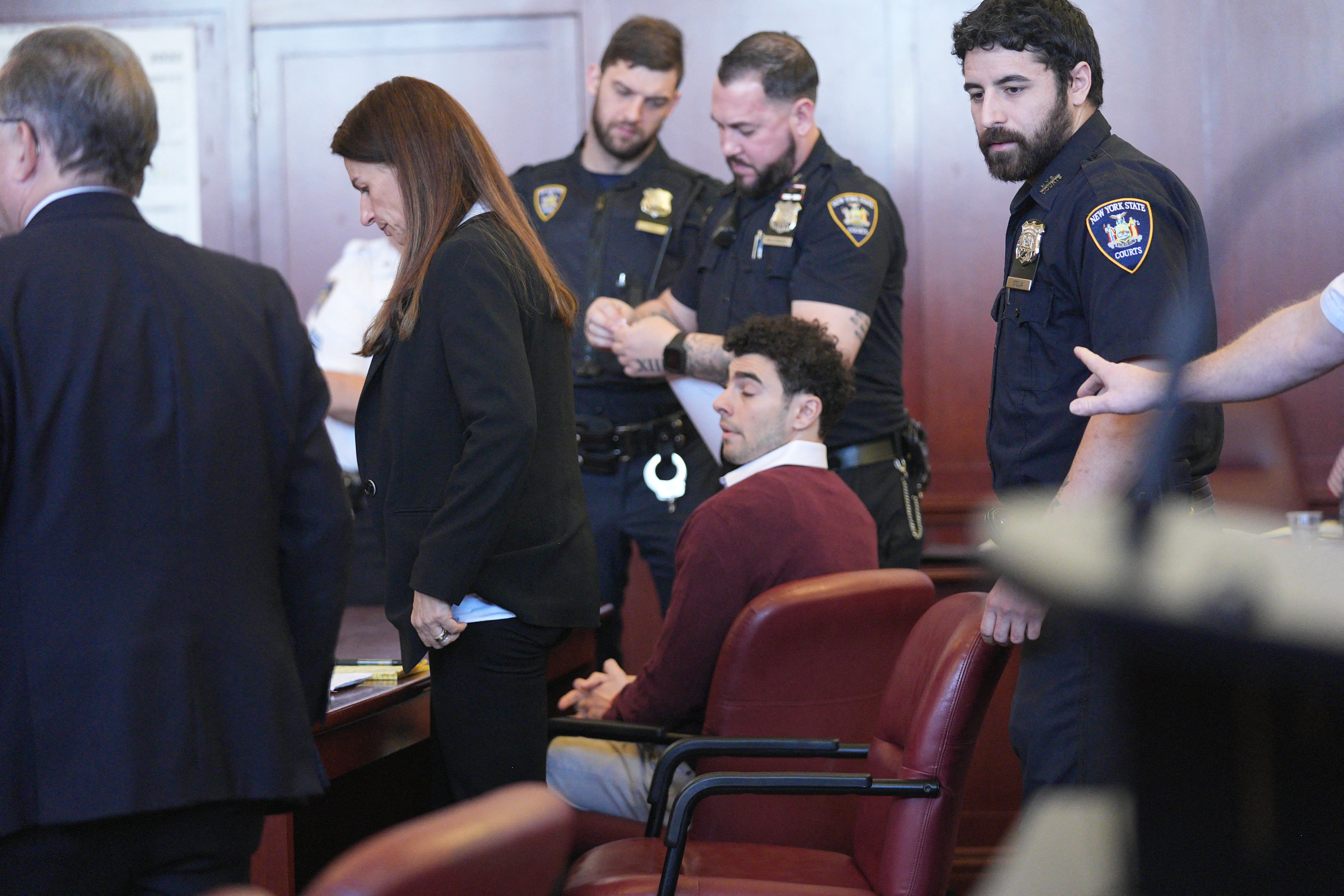 Luigi Mangione sits in a New York courtroom for an arraignment hearing on December 23