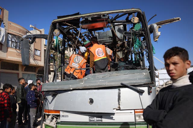 <p>File. Rescuers inspect the carcass of a bus hit by an Israeli strike in Al Mawasi, Gaza </p>