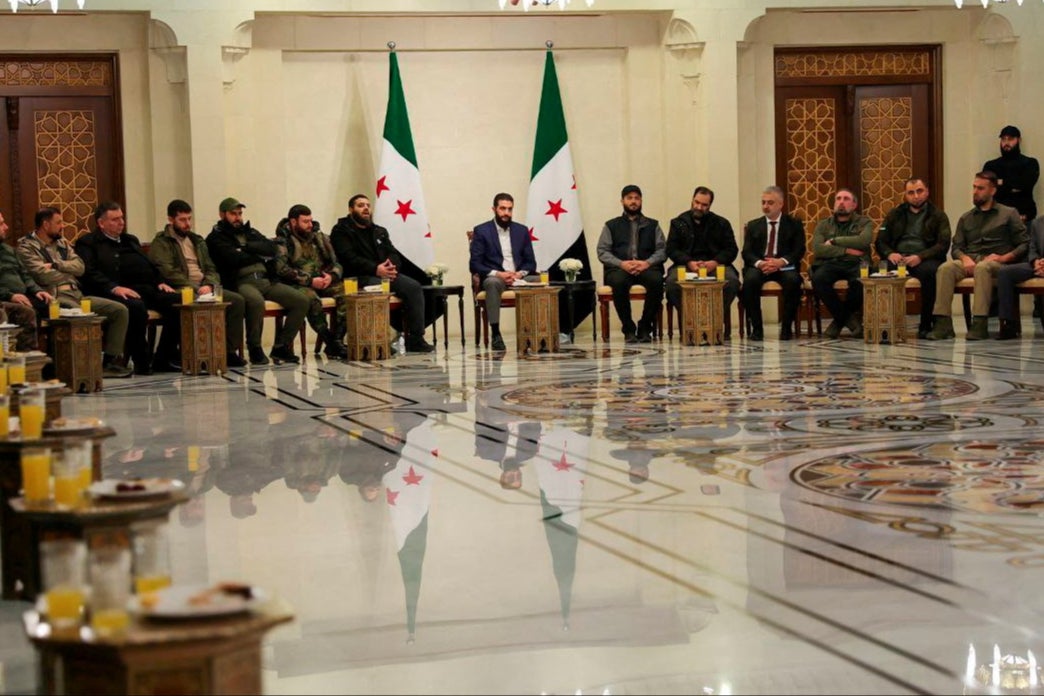 Syria’s de facto leader Ahmed al-Sharaa attends a meeting with former rebel faction chiefs on Tuesday