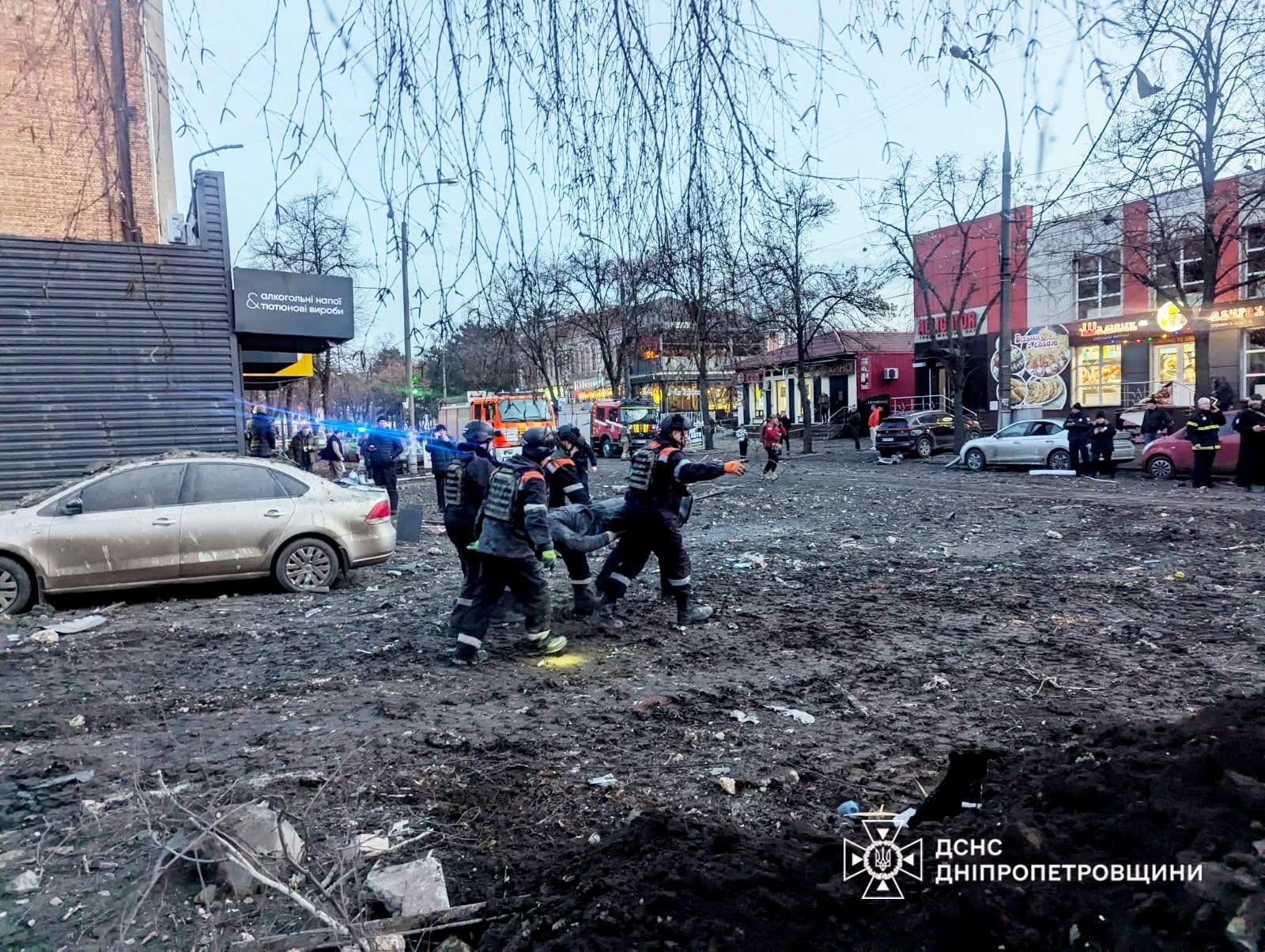 Rescuers evacuate a local resident from a residential building heavily damaged during a Russian missile attack on Christmas Eve