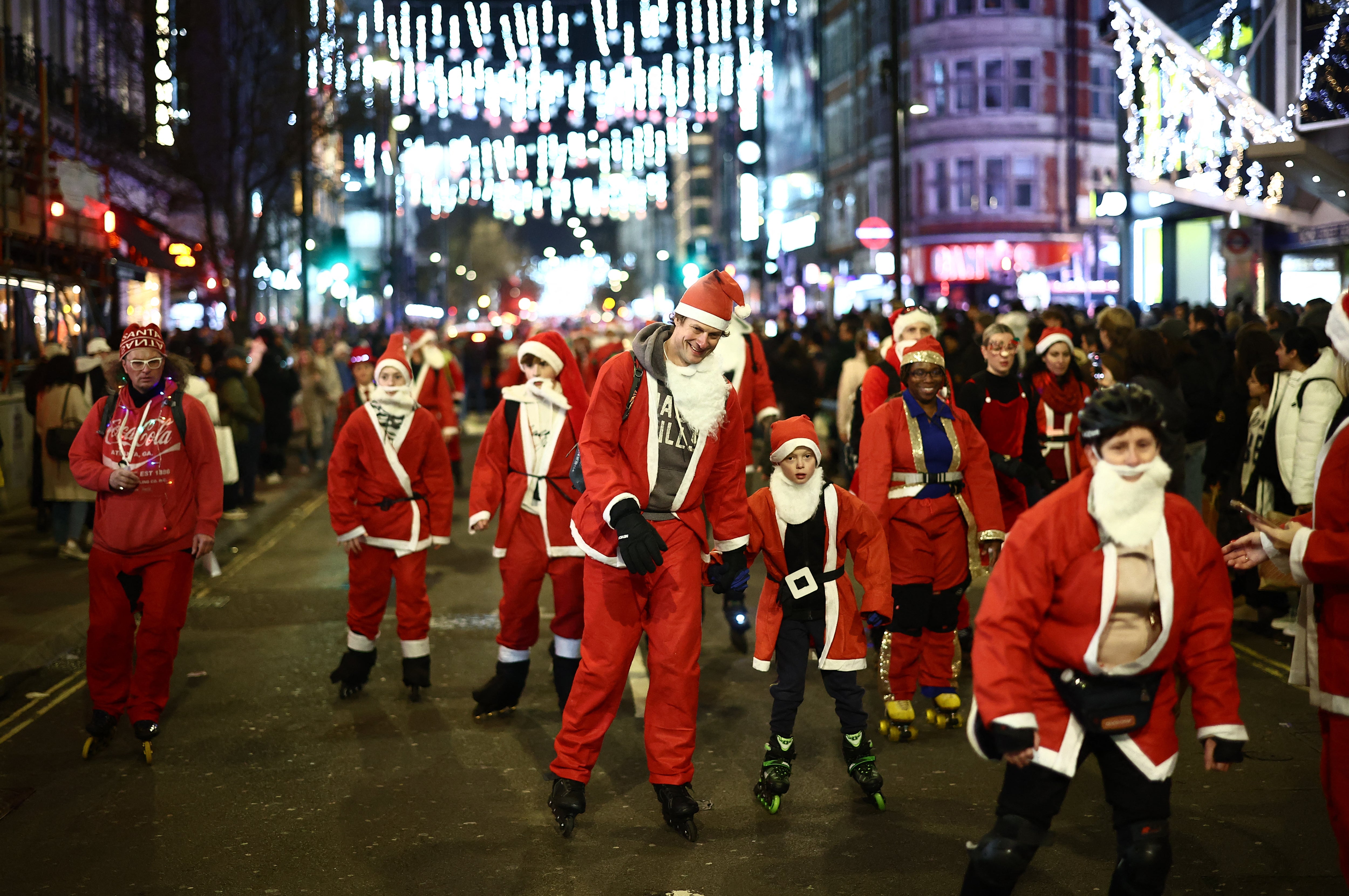 Skaters in festive fancy dress, some as Santa or Father Christmas, attend a Christmas-themed SantaSkate through central London, on Oxford Street, on December 14, 2024.