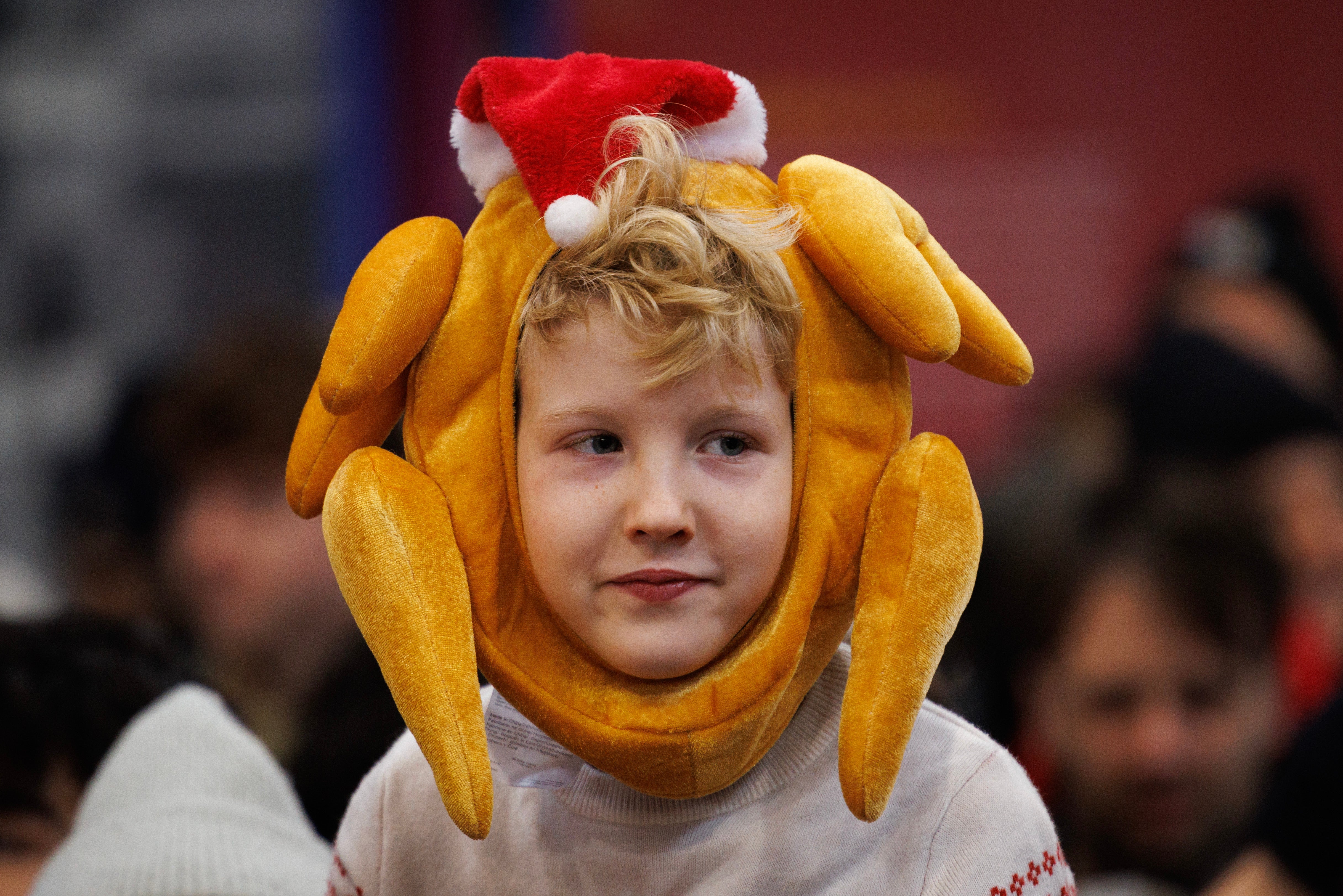 A boy pictured at the annual Christmas Eve meat sale at Smithfield Market on December 24, 2024 in London, England.