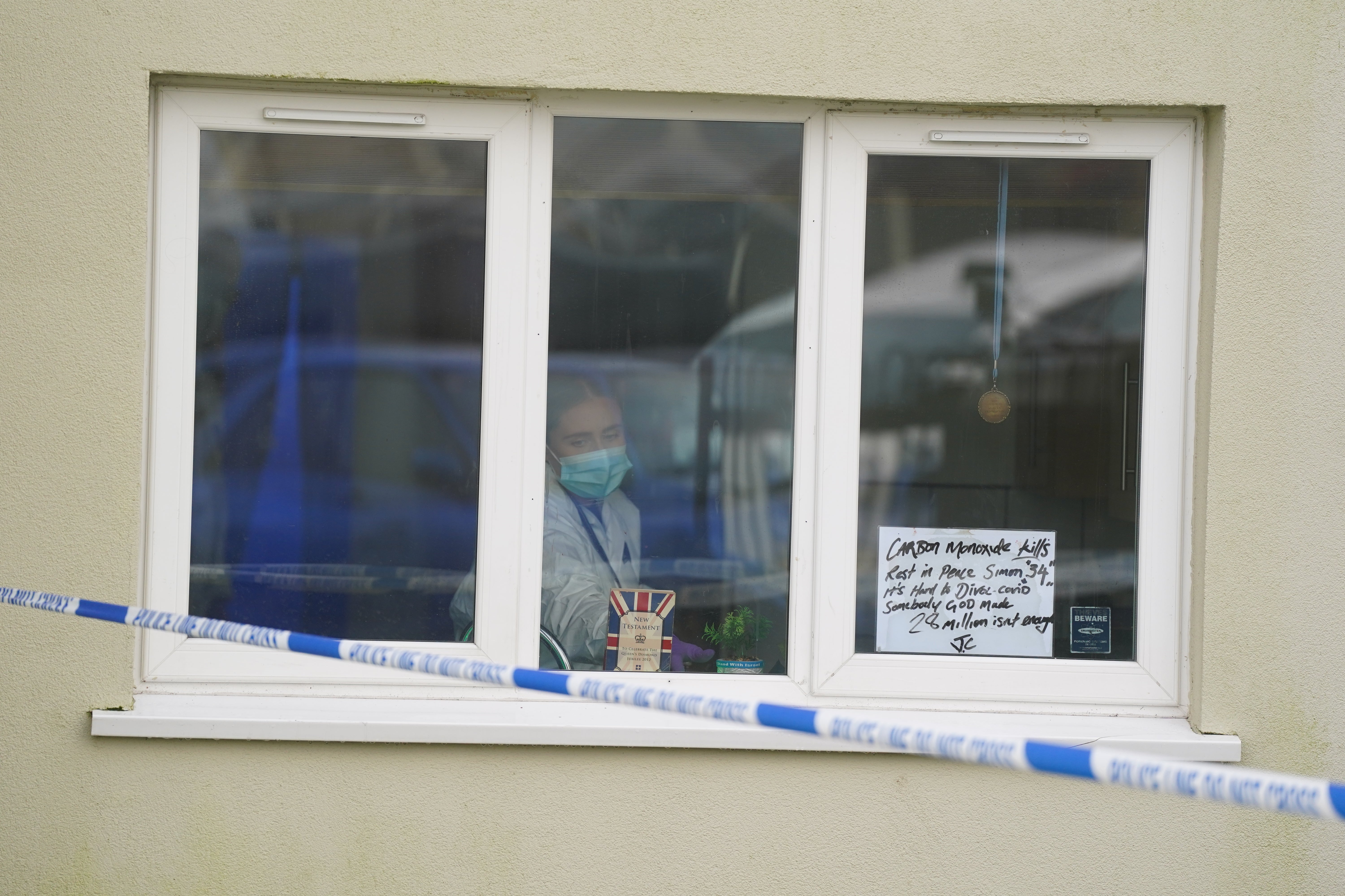 A forensic investigator inside a property at Fownhope Close in Redditch, Worcestershire, where a 39-year-old man was shot by armed police on Christmas Eve.