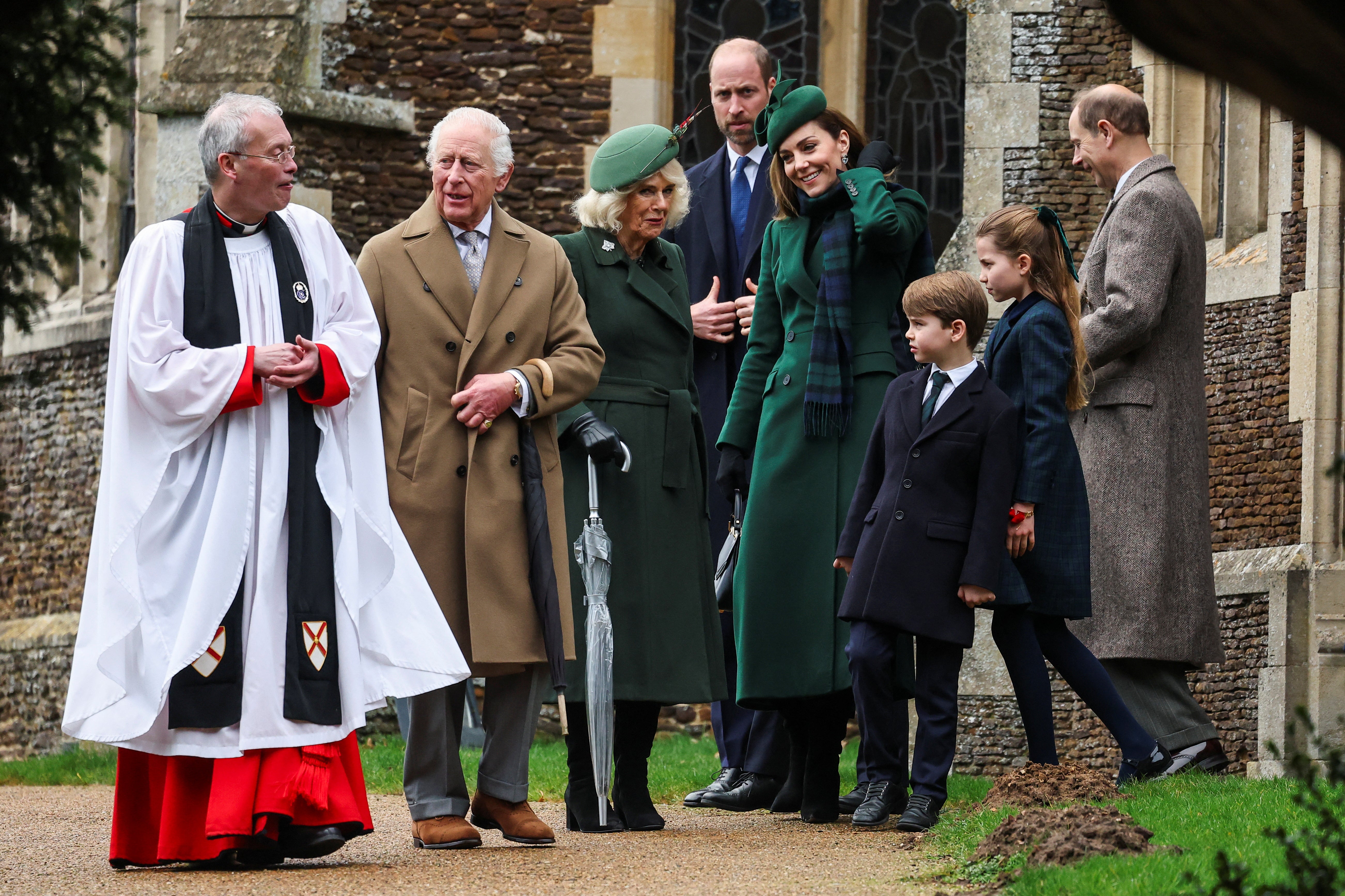 King Charles speaks with Reverend Canon Dr Paul Williams, as Queen Camilla, Catherine, Princess of Wales, William, Prince of Wales, Prince Louis and Princess Charlotte leave the church