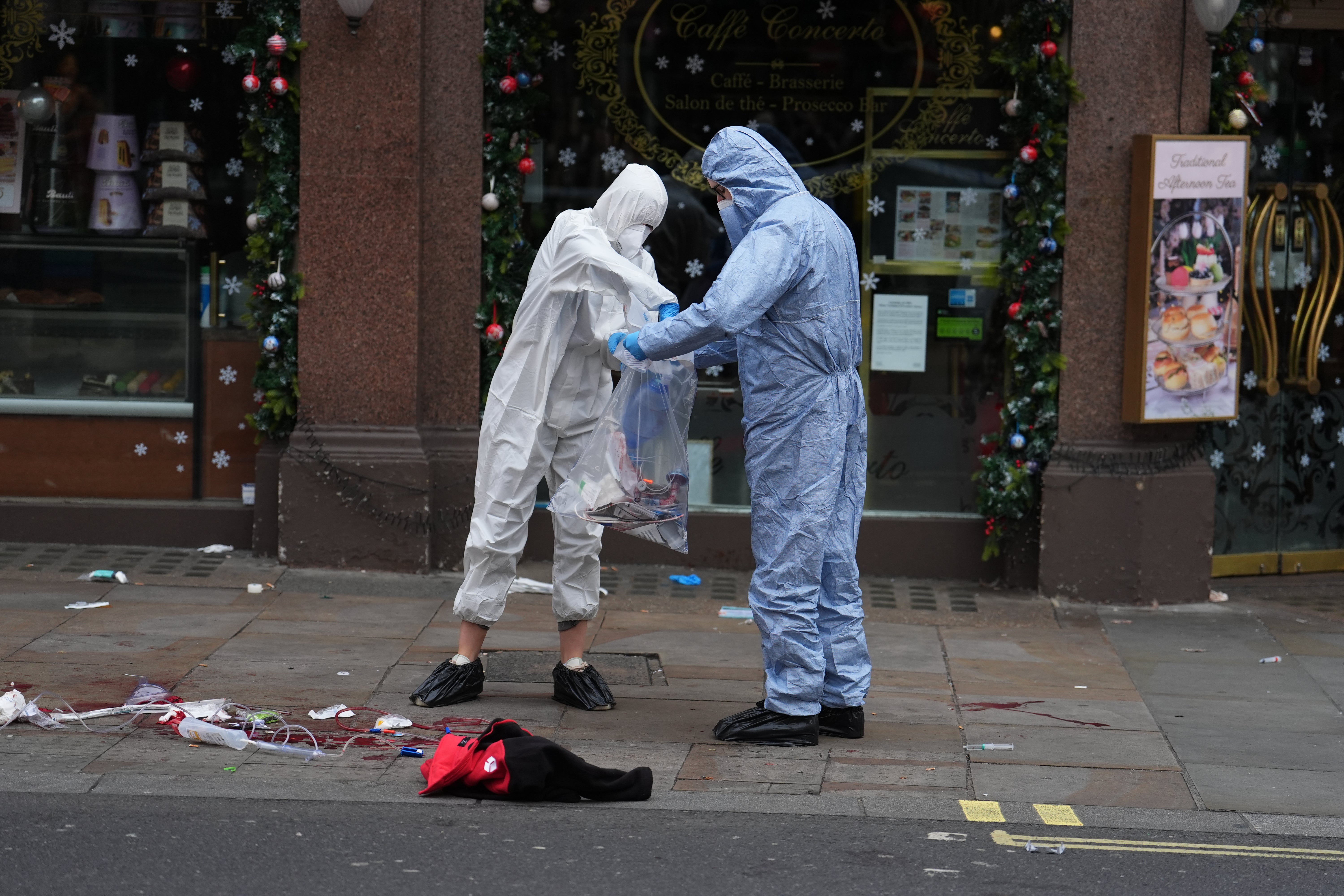 Forensic investigators collect evidence at the scene on Shaftesbury Avenue