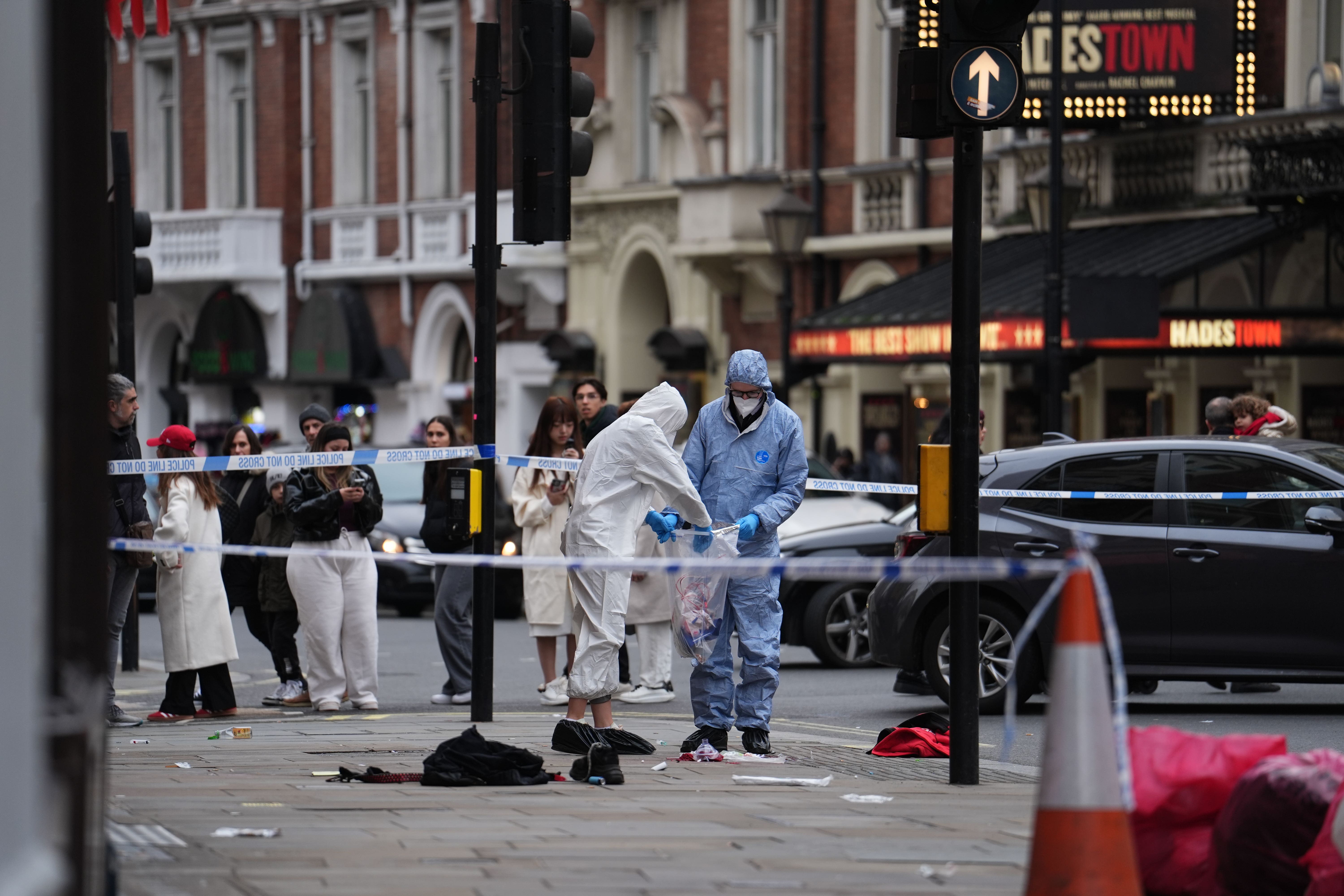 Forensic investigators collect evidence at the scene on Shaftesbury Avenue in central London (Jordan Pettitt/PA)