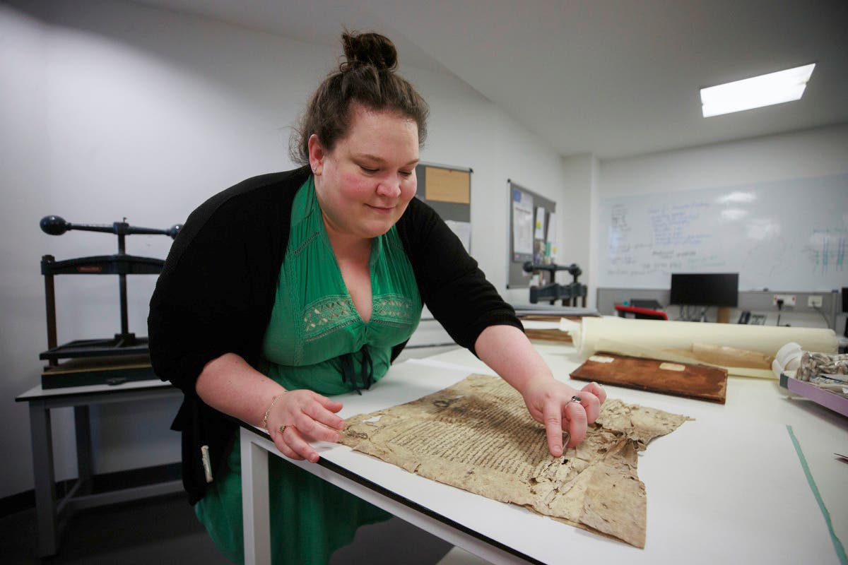 Sarah Graham, head of conservation at PRONI, conserving one of the oldest paper documents still in existence on the island of Ireland, at the Public Record Office of Northern Ireland (PRONI) in Belfast. PA Photo. Picture date: Monday December 16 2024. See PA story ULSTER Archive. Photo credit should read: Liam McBurney/PA Wire