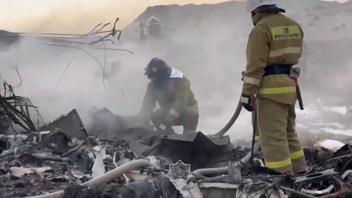 Emergency services arrive at the Azerbaijan Airlines plane crash wreckage site