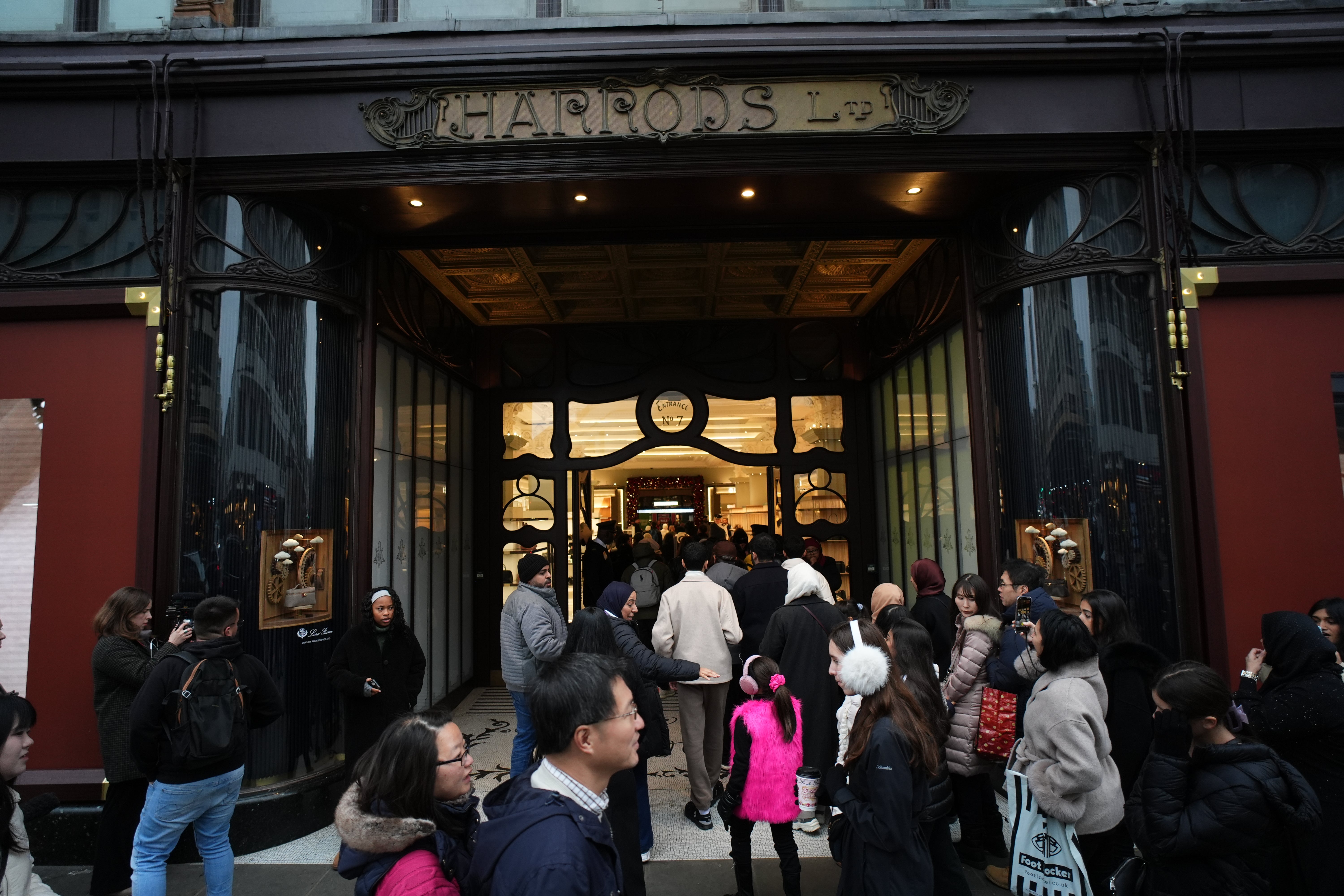 Shoppers enter the store at the start of the Boxing Day sales at the Harrods store in Knightsbridge