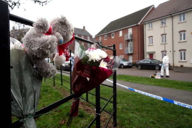 <p>Tributes left near the police cordon in Newton Leys, near Bletchley, after two women were killed in an alleged Christmas Day stabbing</p>