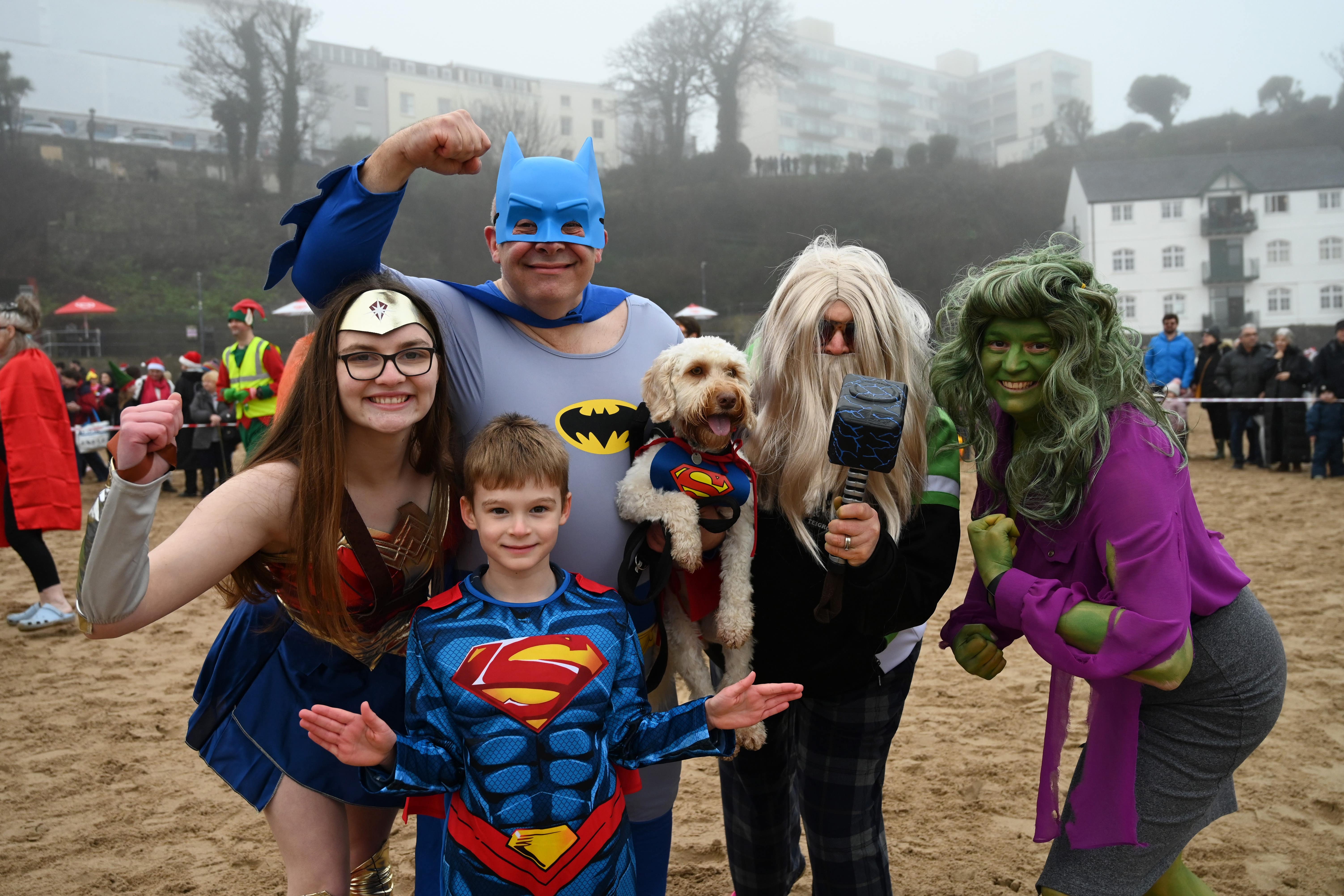 People take part in the annual Tenby Boxing Day swim dressed as superheroes (Gareth Davies Photography/Tenby Boxing Day Swim/PA)
