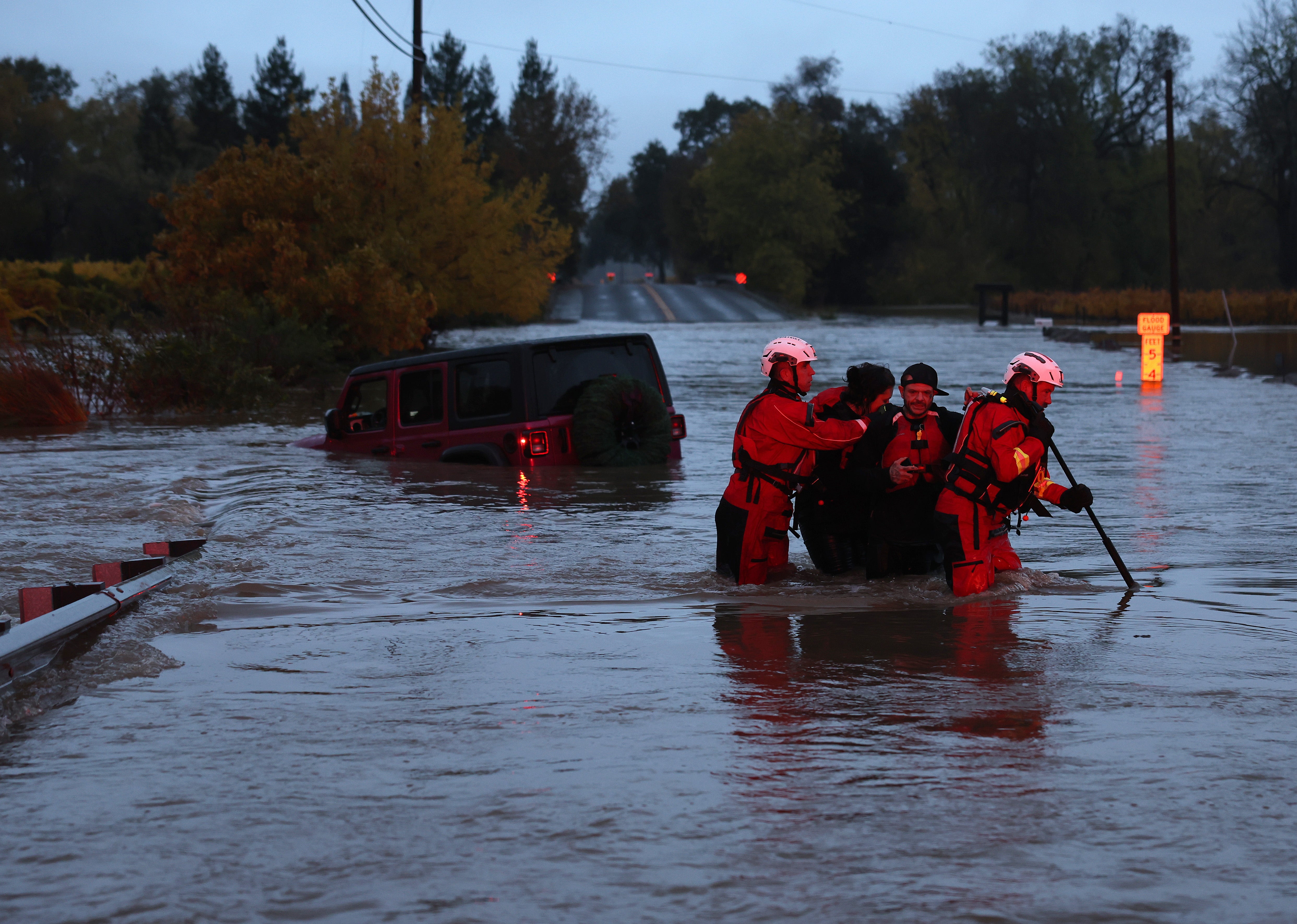 Firefighters rescue a couple after their car got stuck in deep floodwaters last month in Windsor, California. The state has been hammered by multiple atmospheric river storms this year