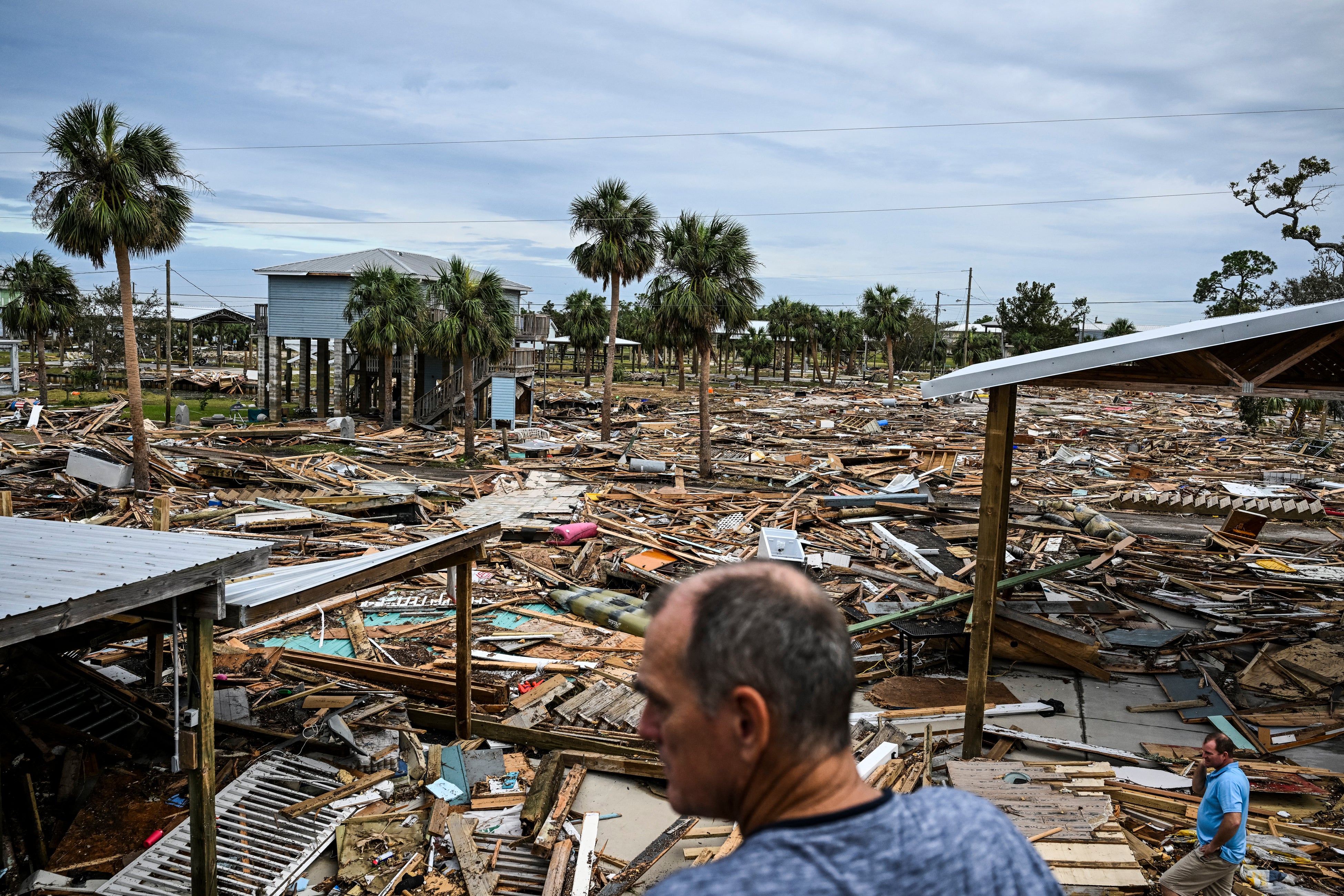 David and Bo Hester inspect the area after Hurricane Helene made landfall in Horseshoe Beach, Florida, last September. Helene ravaged mountainous communities in western North Carolina