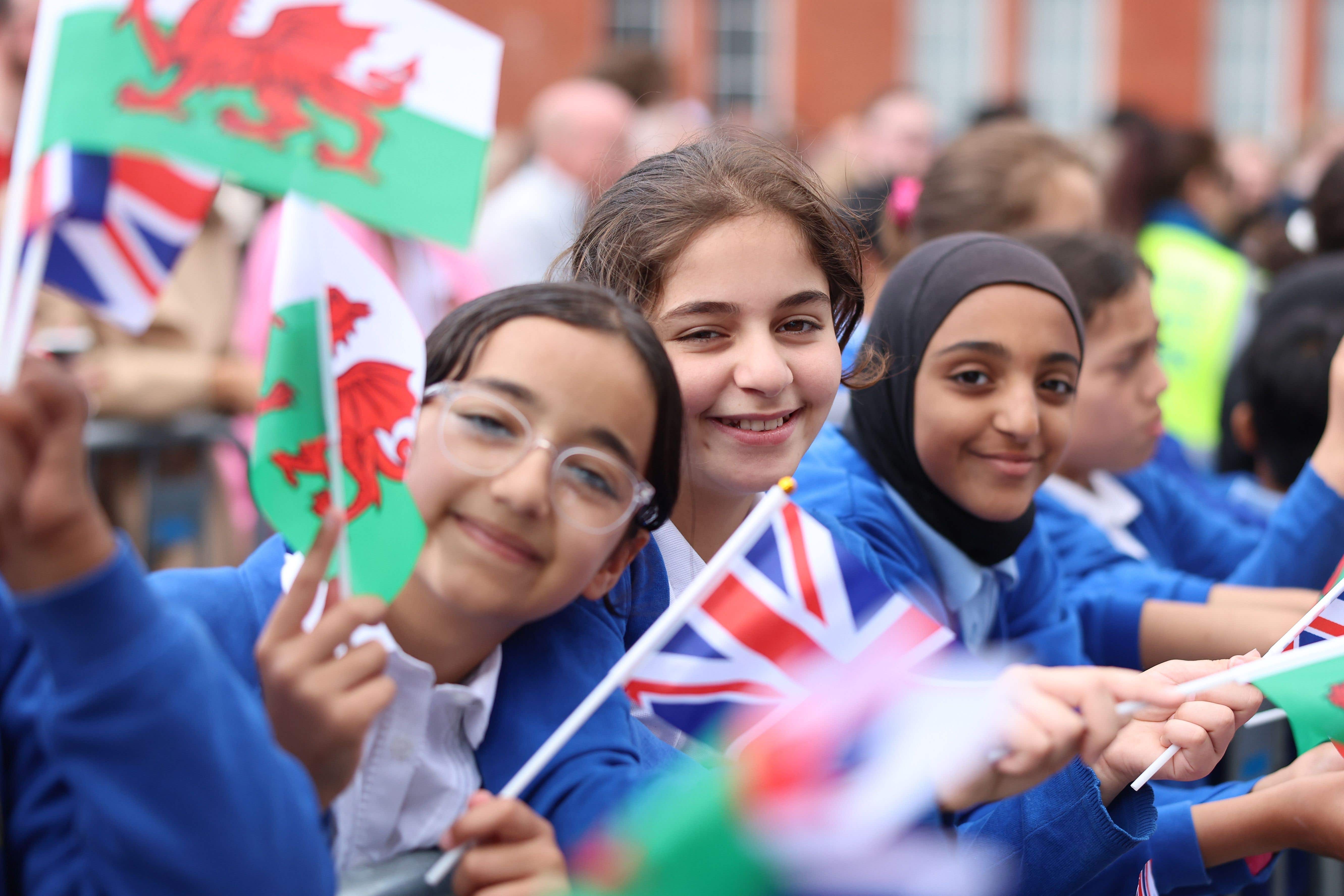 Schoolchildren wave flags outside the Senedd ahead of the King’s arrival to mark its 25th anniversary in July (Chris Jackson/PA)