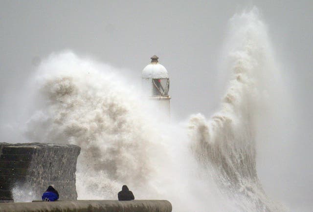 <p>Huge waves crash over the seafront in Porthcawl, south Wales, during Storm Darragh in December </p>