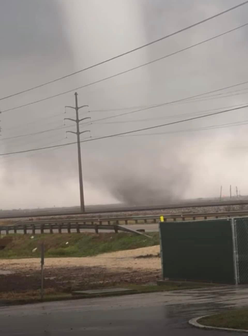 A twister is seen in Wharton County, Texas. Videos showed the grey funnel moving through the area