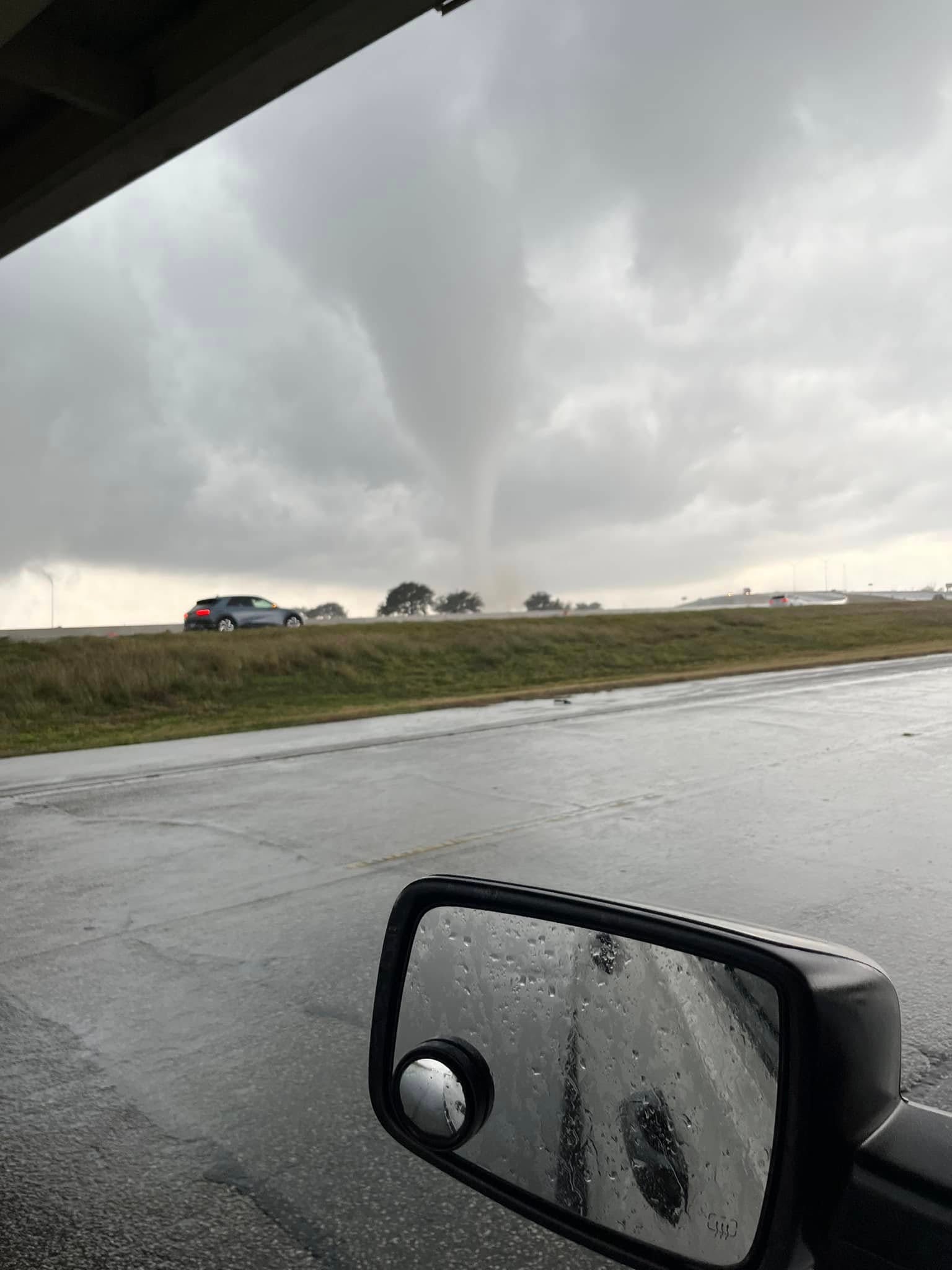 A tornado is seen out a car window. There were also reports of thunderstorms around Louisiana