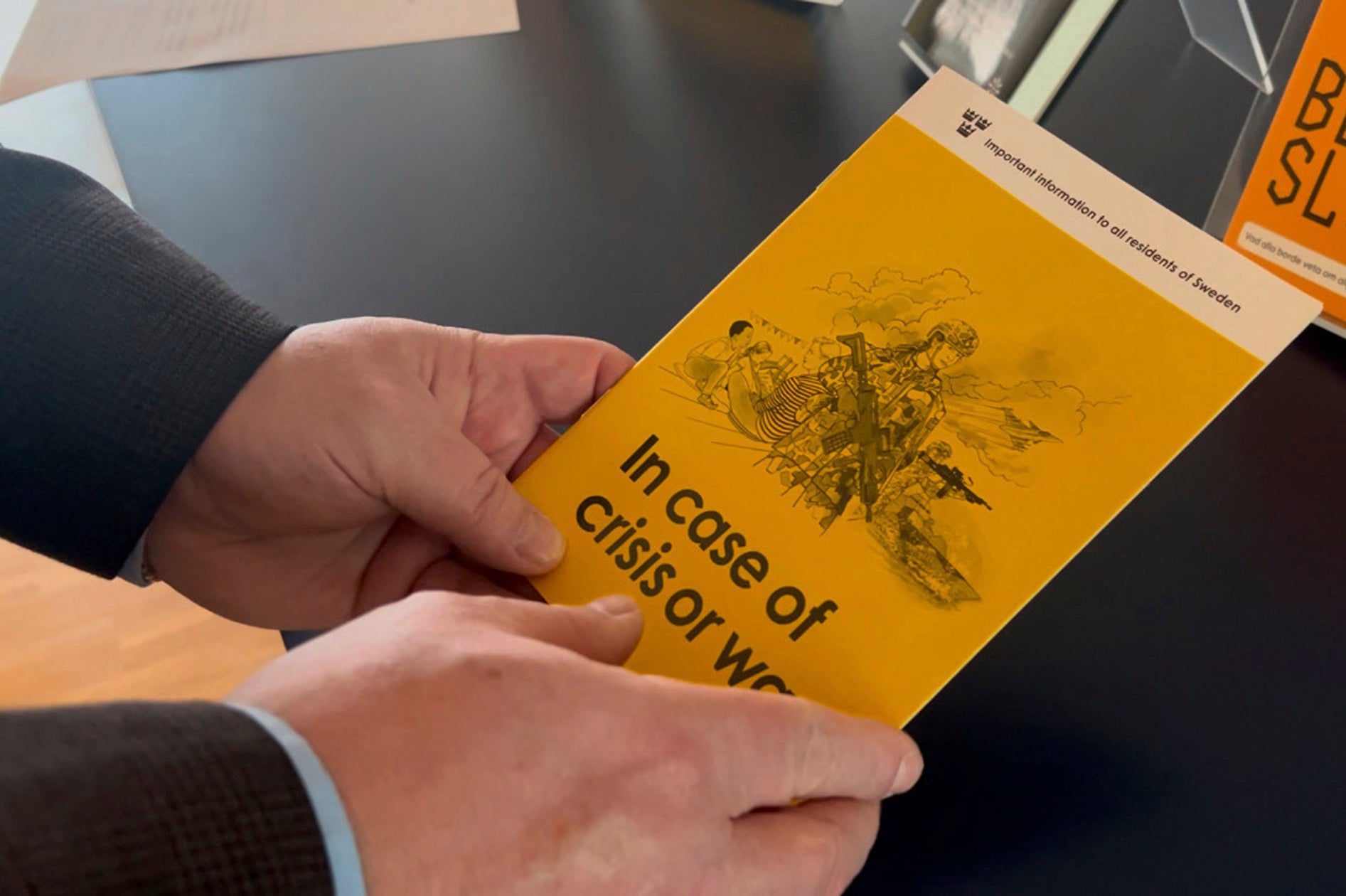 Jan-Olof Olsson, Critical Infrastructure Protection (CIP) expert at the Swedish Civil Contingencies Agency (MSB) holds a yellow crisis preparedness brochure titled "In case of crisis or war", which was distributed to all Swedish households, Thursday, Dec. 26, 2024, in Karlstad, Sweden