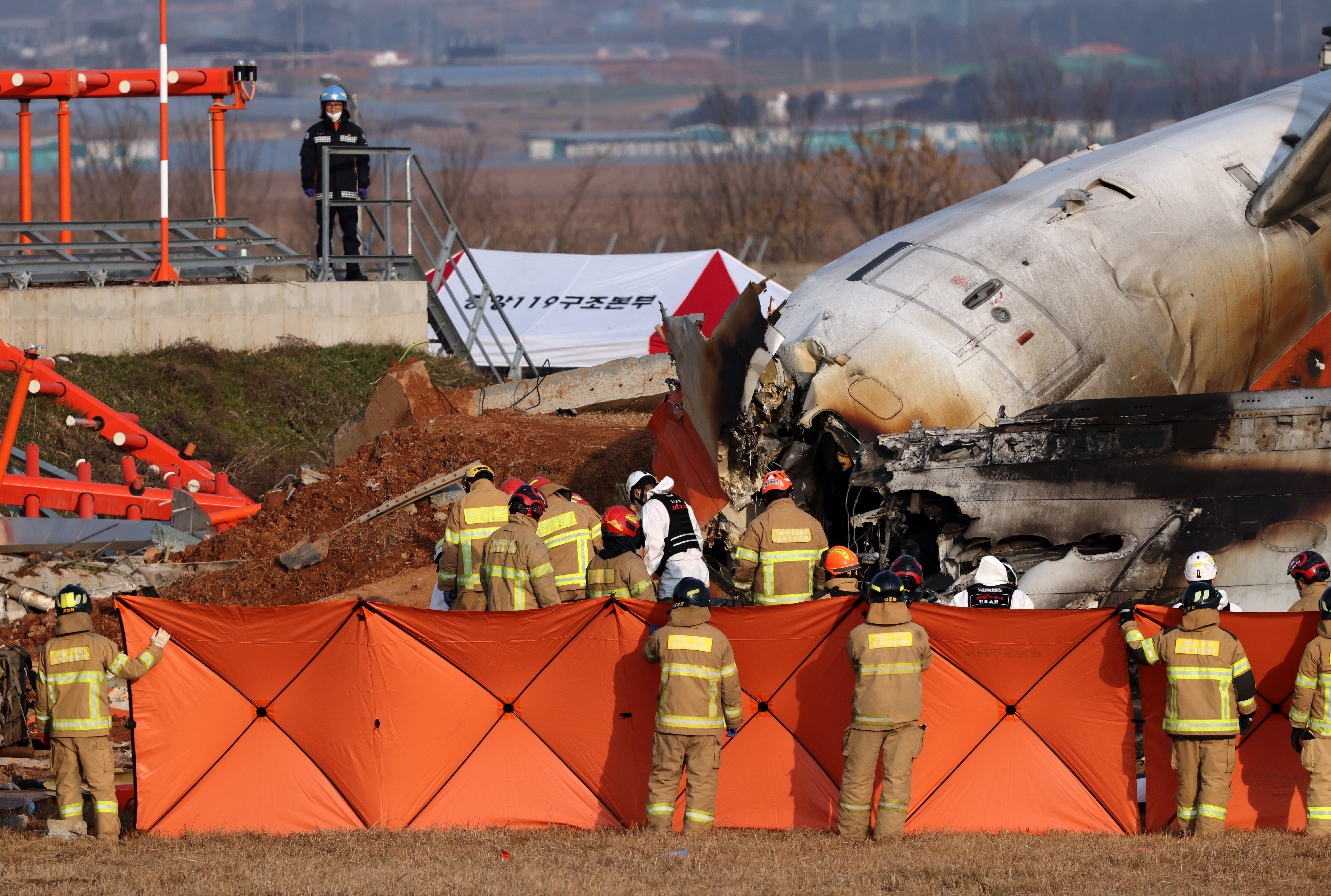 Firefighters search the wreckage