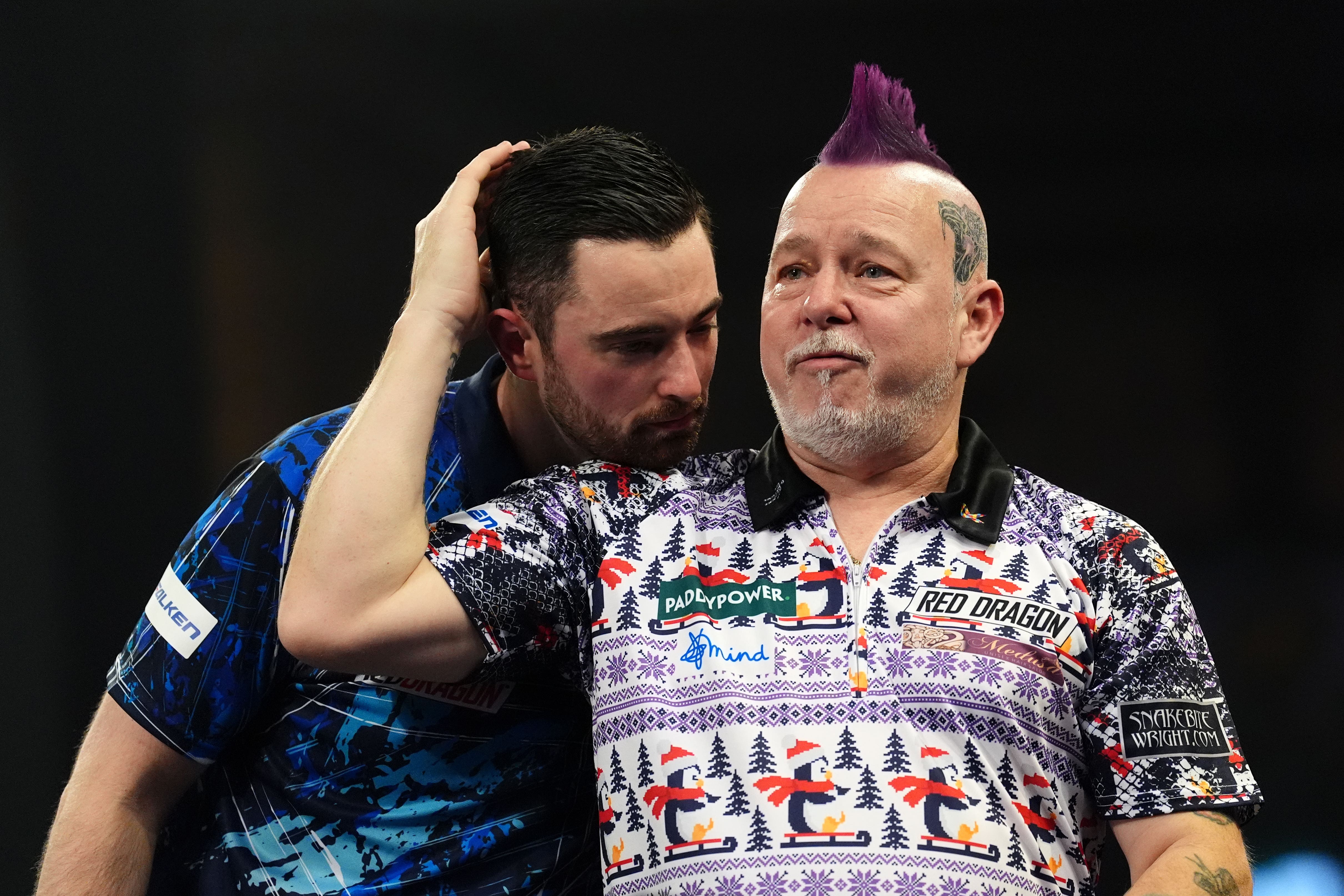 Peter Wright reacts to his fourth round victory over reigning world champion Luke Humphries at Alexandra Palace (Zac Goodwin/PA)