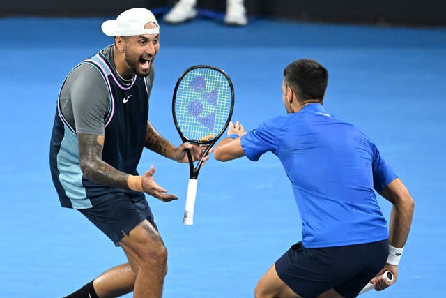 Nick Kyrgios (left) and Novak Djokovic celebrate during their doubles win over Alexander Erler and Andreas Mies in the Brisbane International (Darren England/AAP Image via AP)