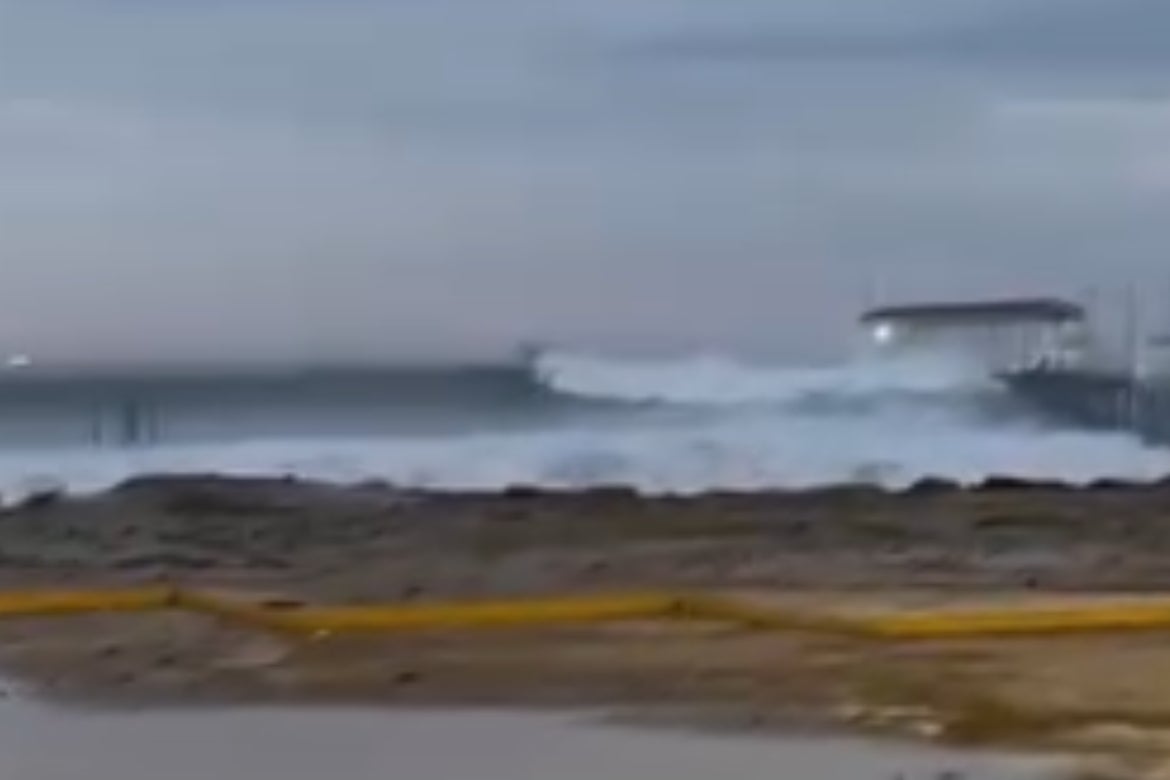 A video captured the moment waves crashed into the roof of the fishing pier Friday