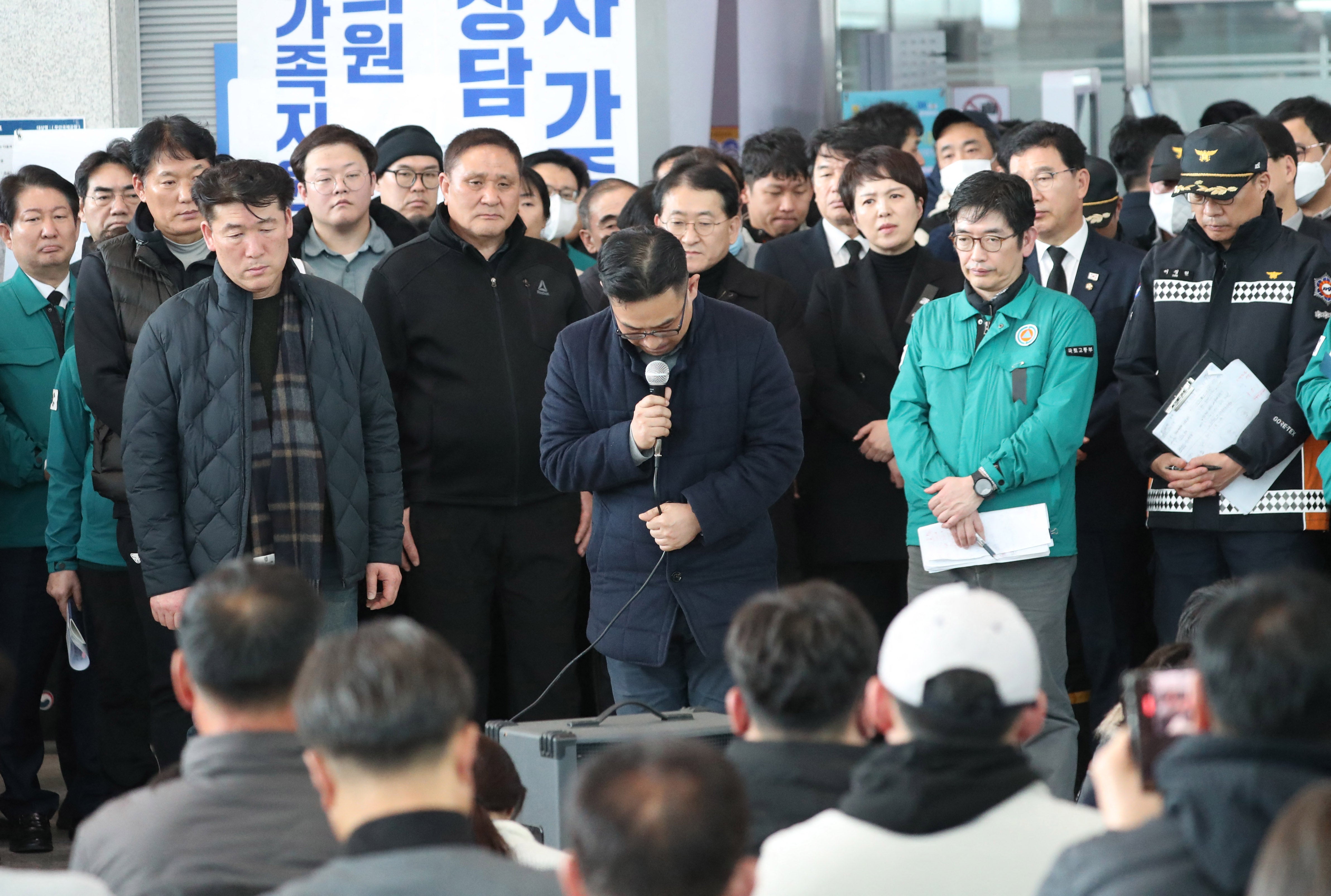 A Jeju Air official bows his head and apologises to the bereaved families