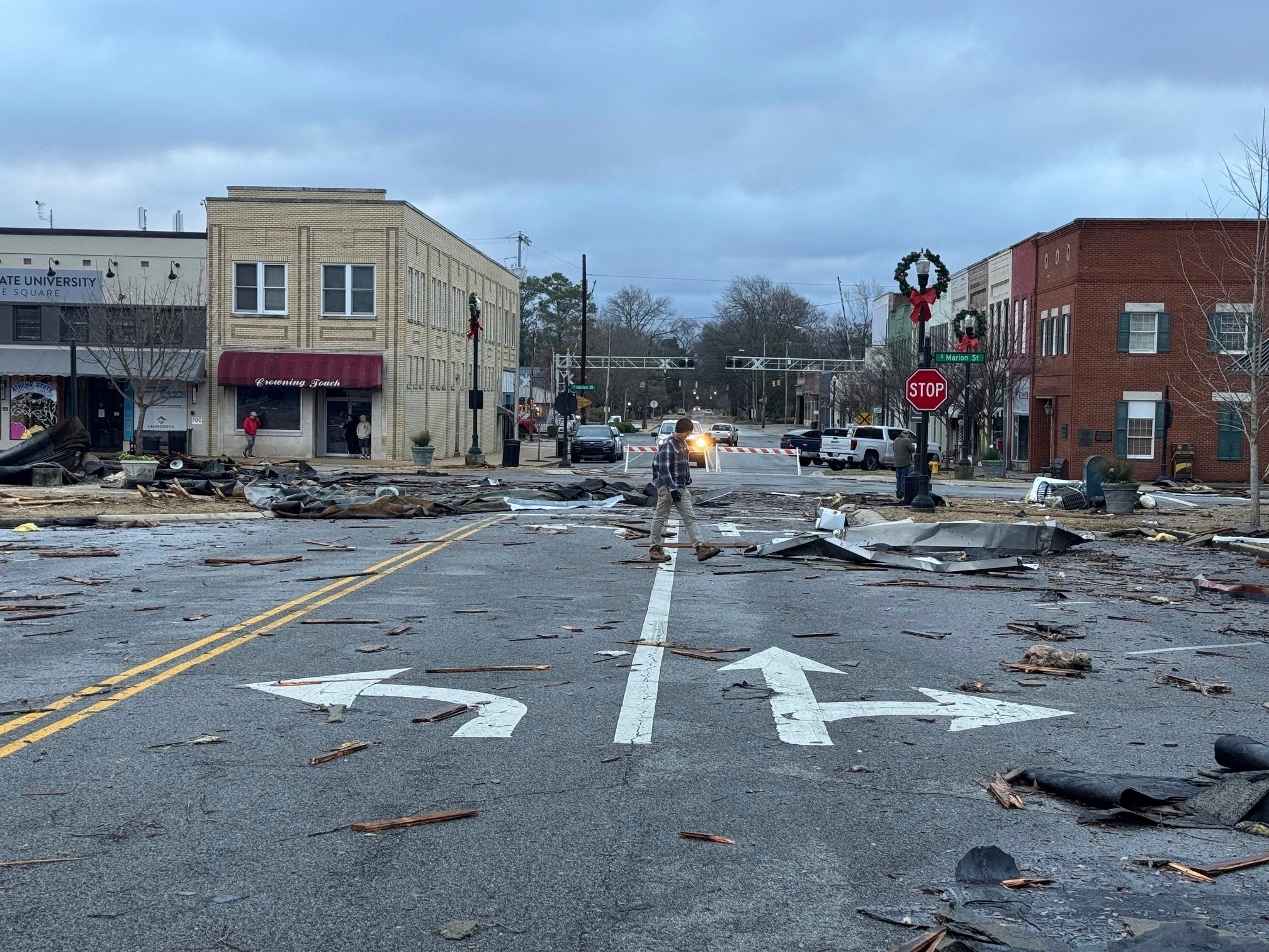 Destruction from the storm is seen in Athens, Alabama, on Sunday as a man walks through the areas. There were multiple reports of damage in the state