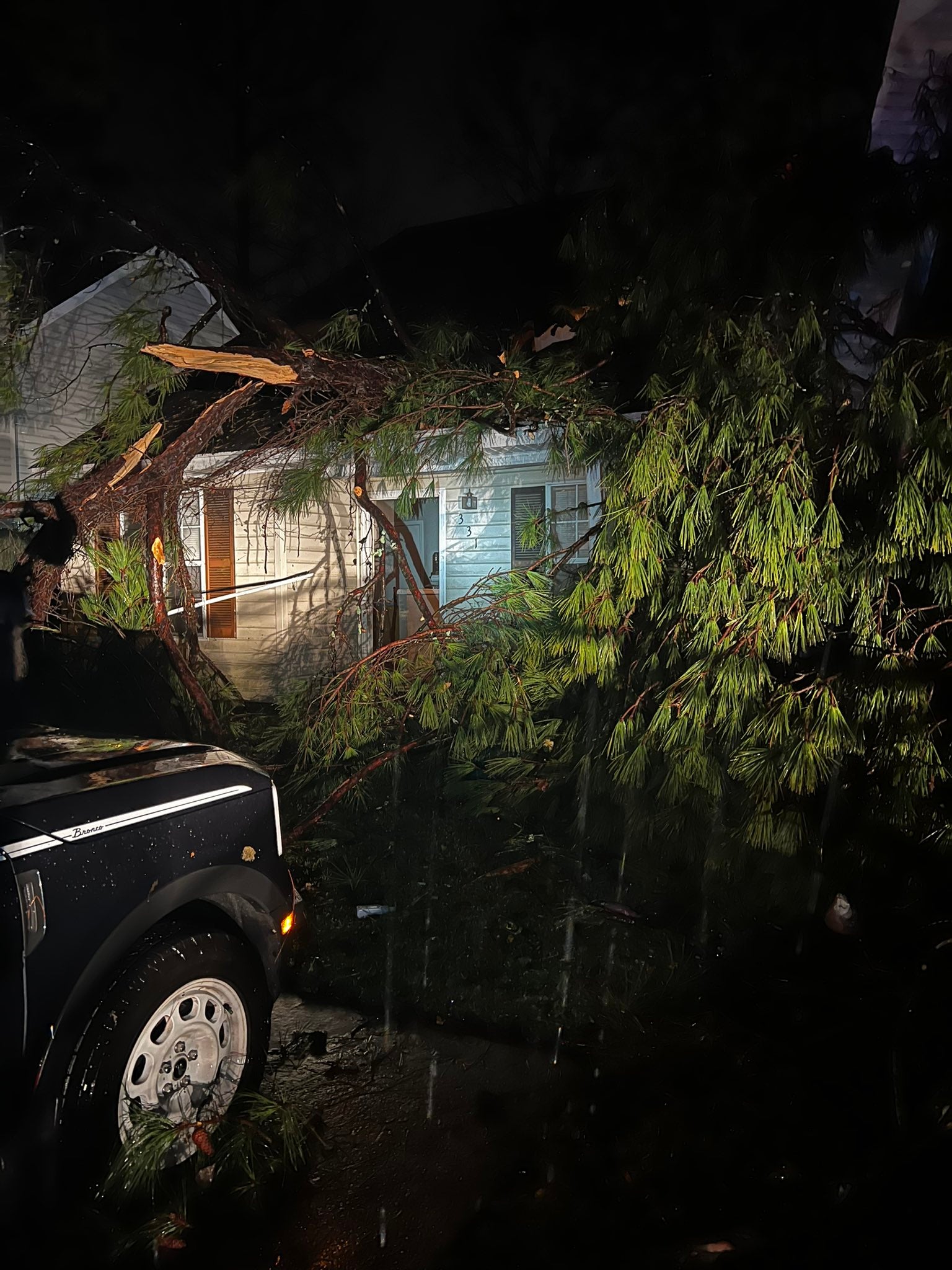 A snapped tree is seen on a roof in Rankin County, Mississippi. There were two fatalities in the state and multiple injuries reported by Governor Tate Reeves