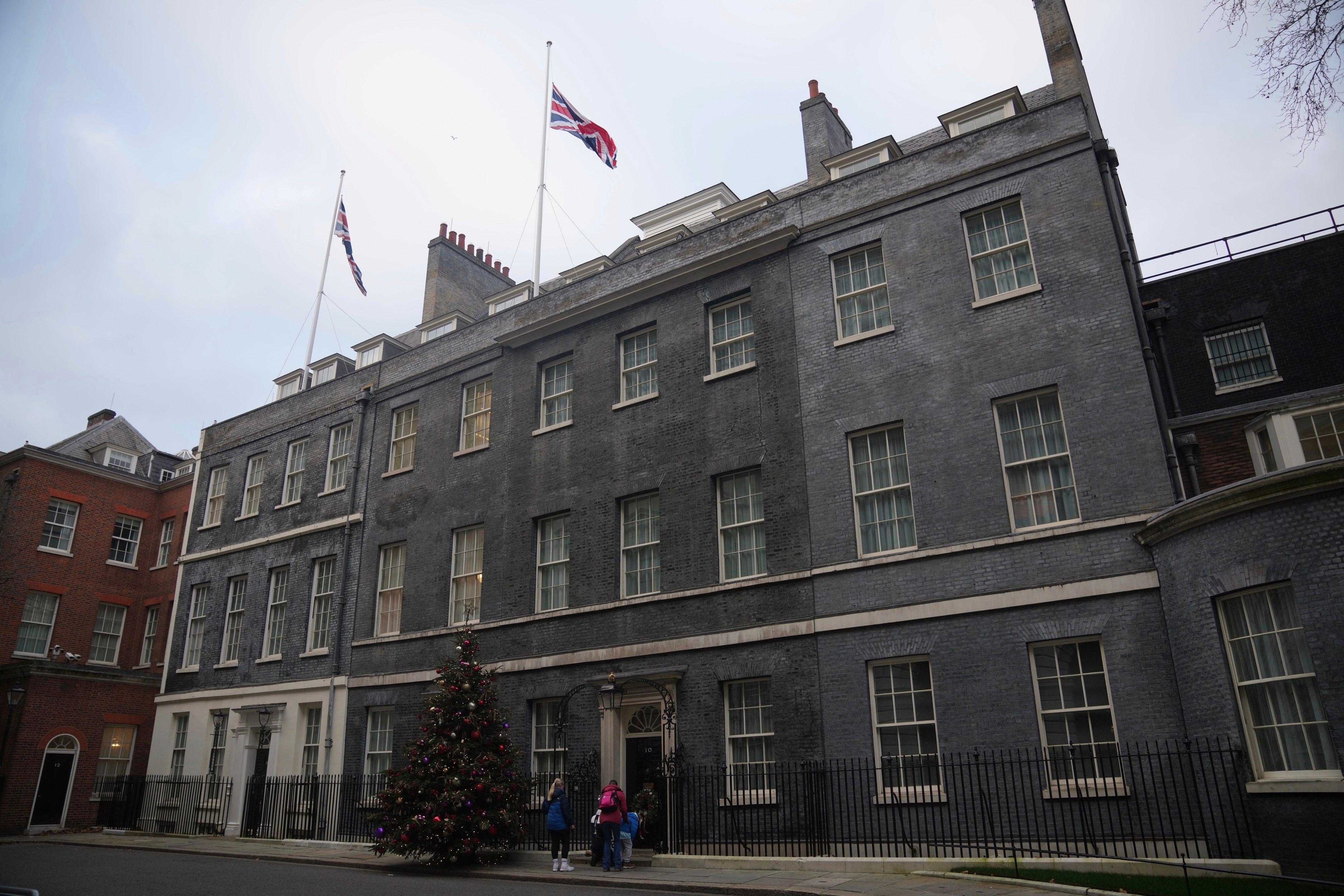 Flags fly at half-mast for the late former U.S. President Jimmy Carter at Downing Street in London on Monday