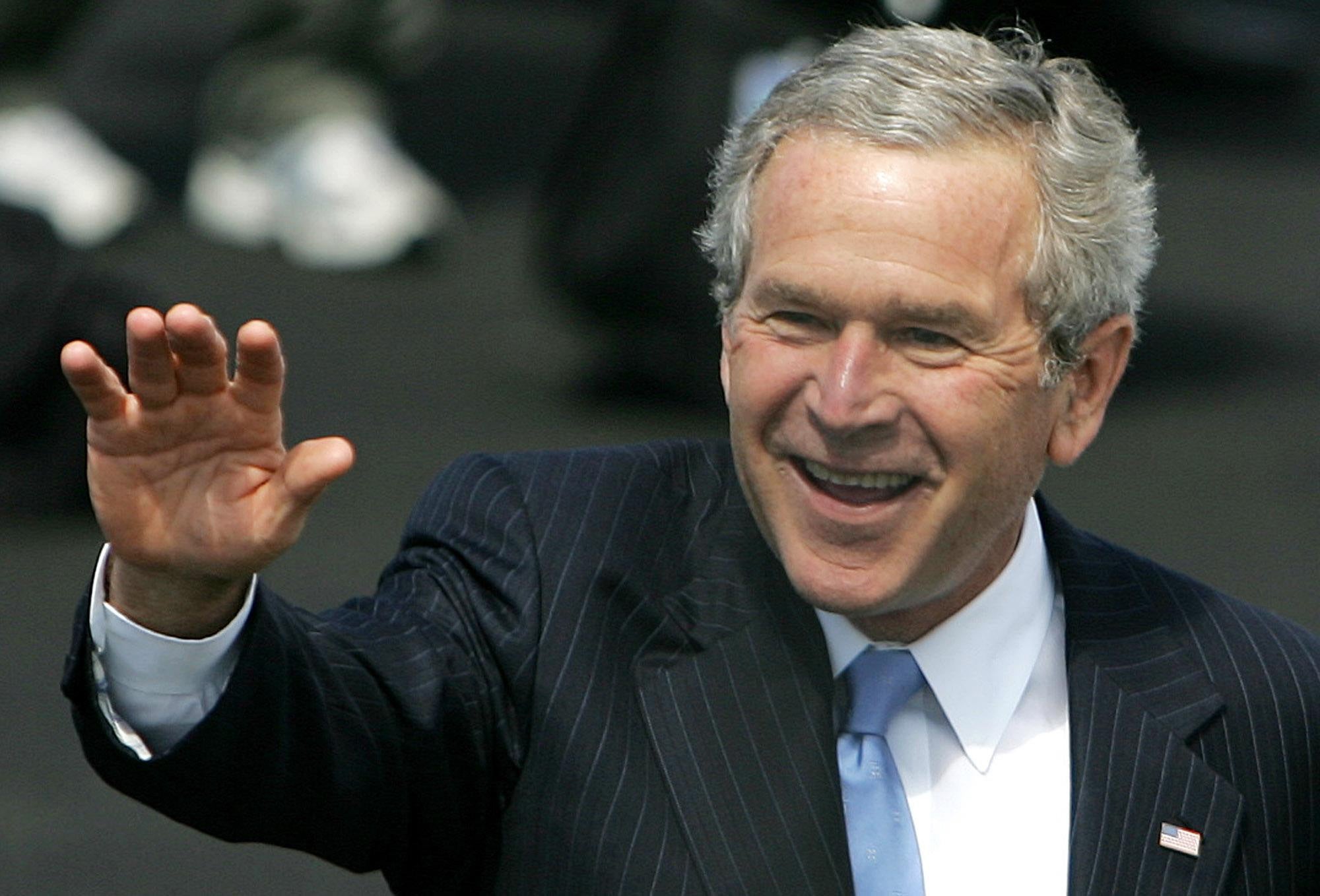 US President George Bush waves at onlookers as he arrives, at Prestwick airport for the G8 Summit at Gleneagles