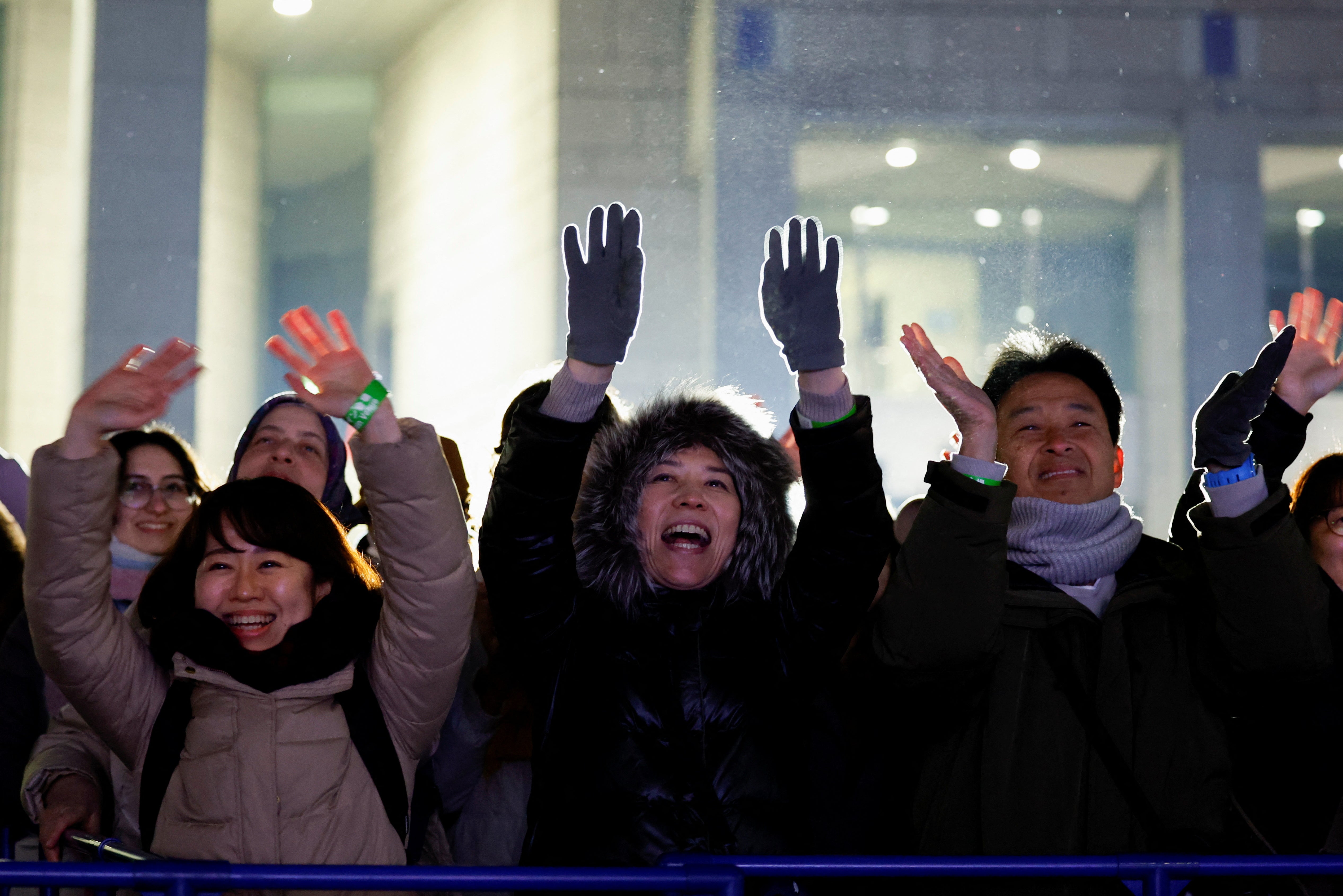 People in Japan react joyfully following the countdown to the end of 2024