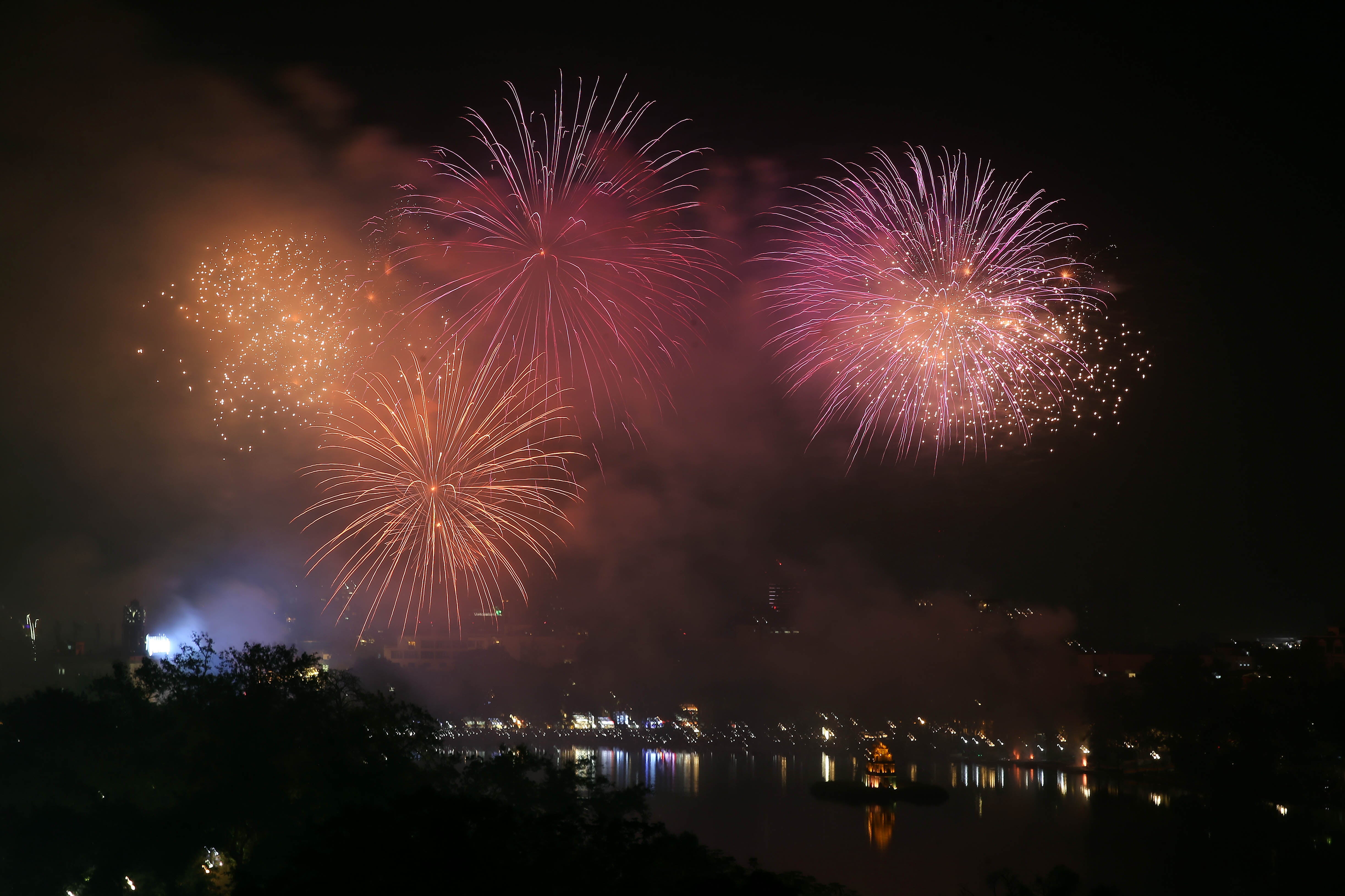 Fireworks illuminate the sky over Hoan Kiem Lake during the New Year's Eve celebrations