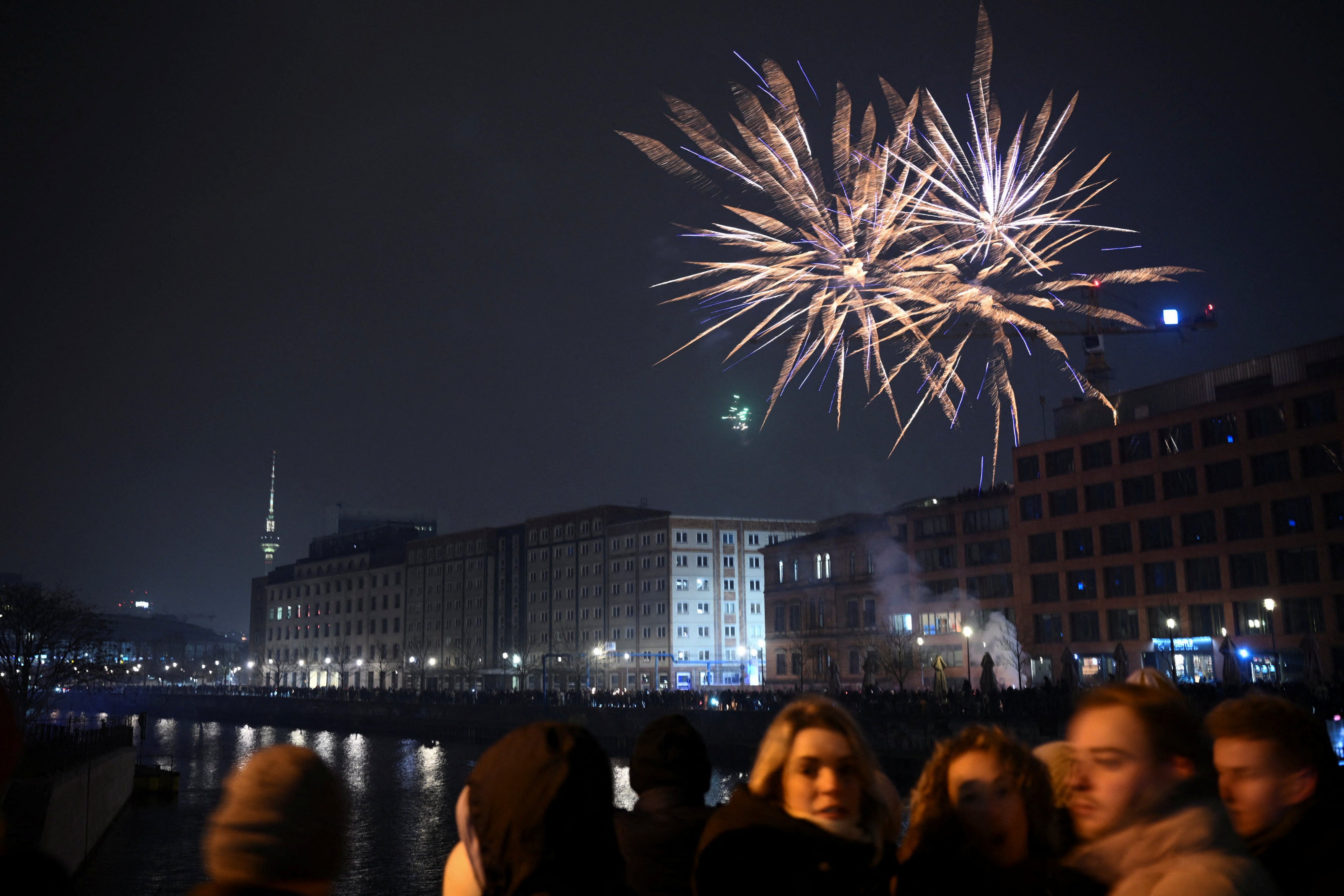 Fireworks burst as people gather for New Year's celebrations in Berlin, Germany