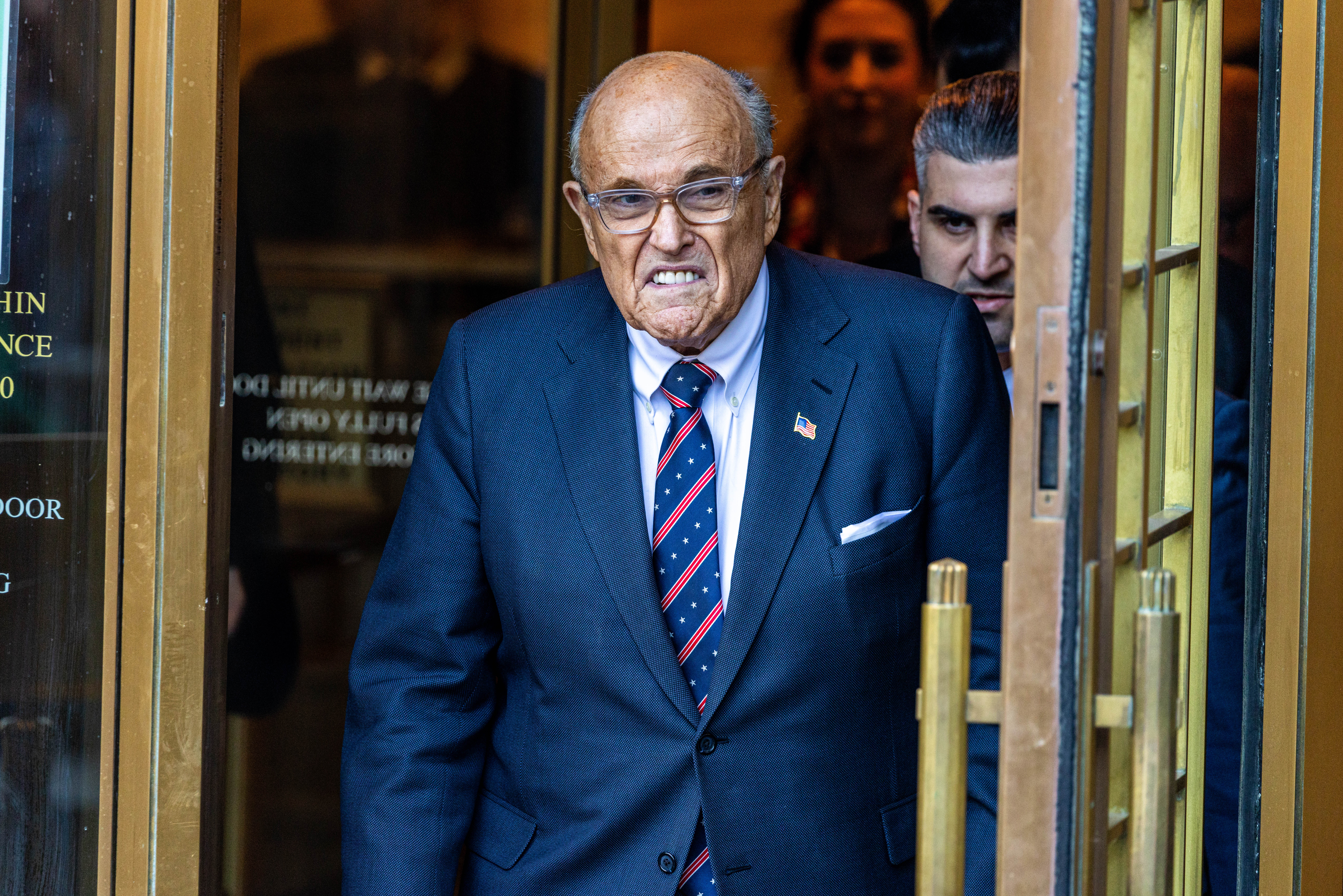 Rudy Giuliani will face a mini-trial in federal court in January to determine if he can exempt his Florida condo from election workers trying to seize his assets to collect on the $150 million defamation verdict against him