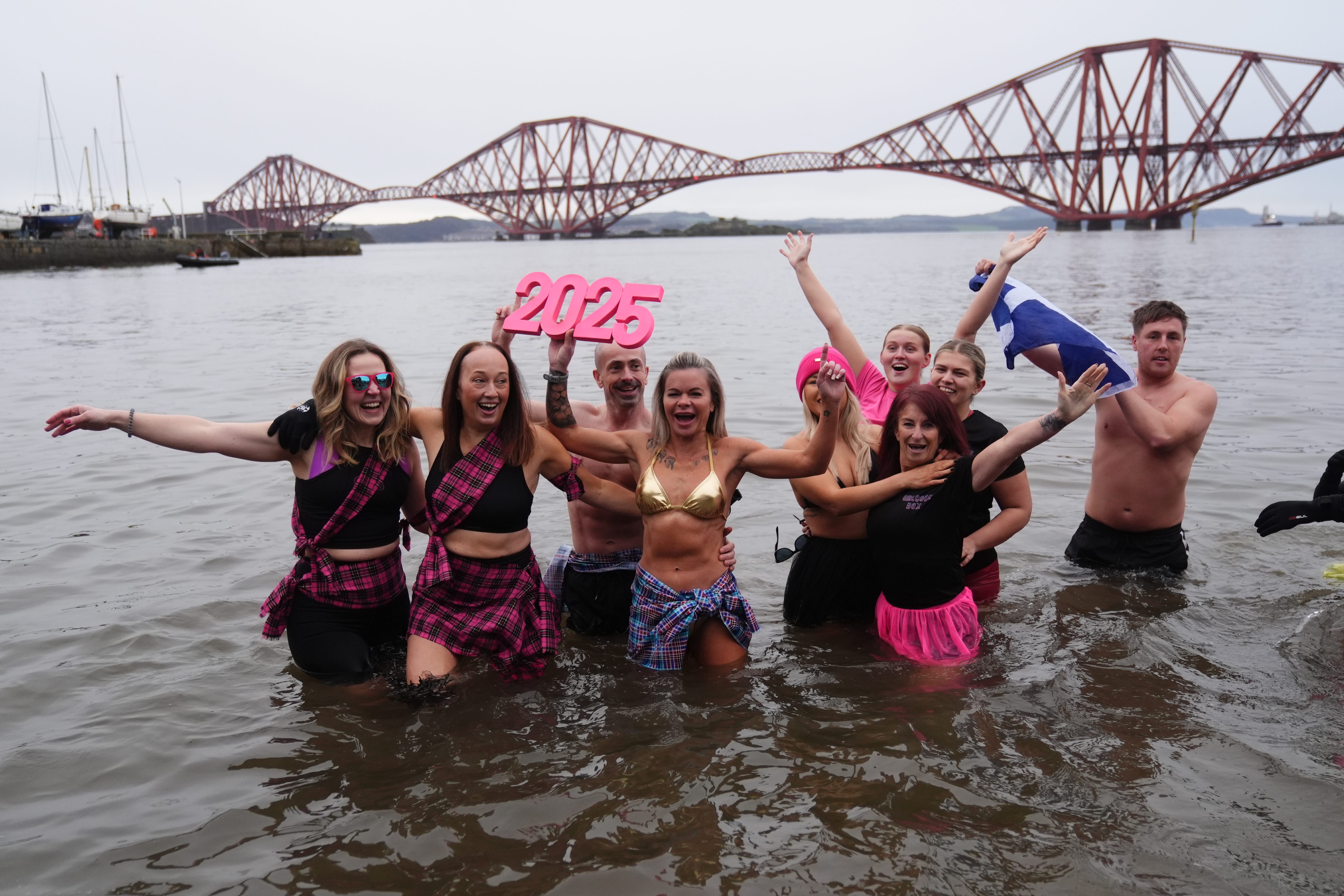 People take part in the Loony Dook New Year’s Day dip in the Firth of Forth at South Queensferry (Andrew Milligan/PA)