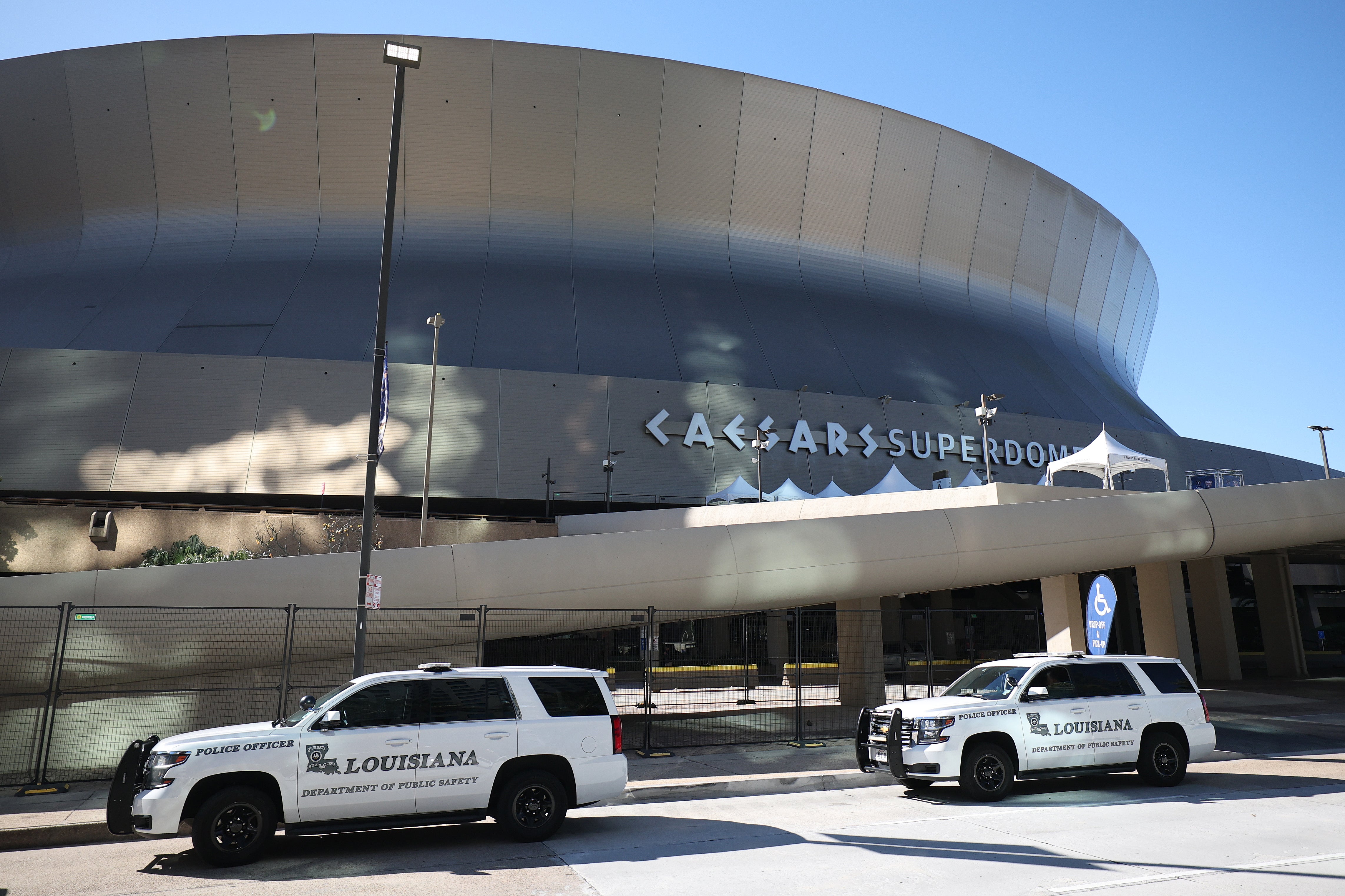 Police cars are outside the Caesars Superdome hours after 10 were killed in New Orleans after a terrorist attack