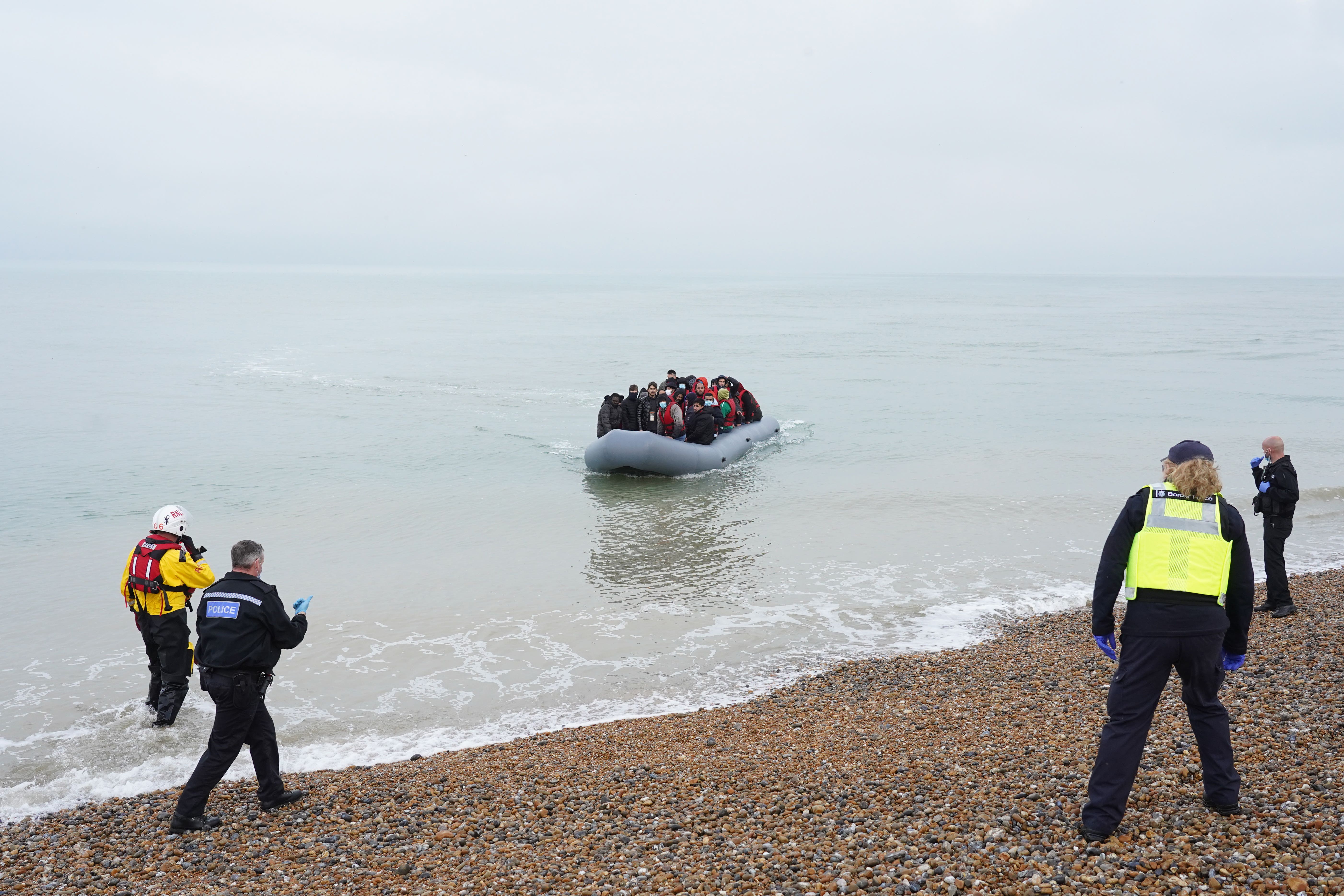 Police and Border Force officers wait to intercept a dinghy carrying people, thought to be migrants, off the coast of Dungeness, Kent (Gareth Fuller/PA)